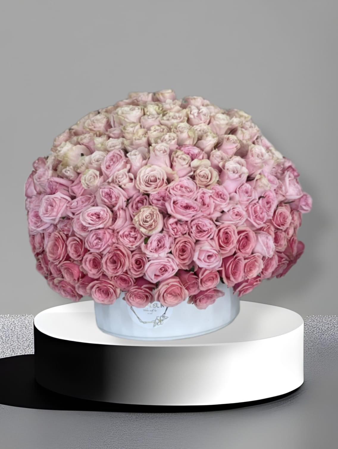 Ombre  - This arrangement comes in a round clay vase filled with filled with three different roses. All around.  
