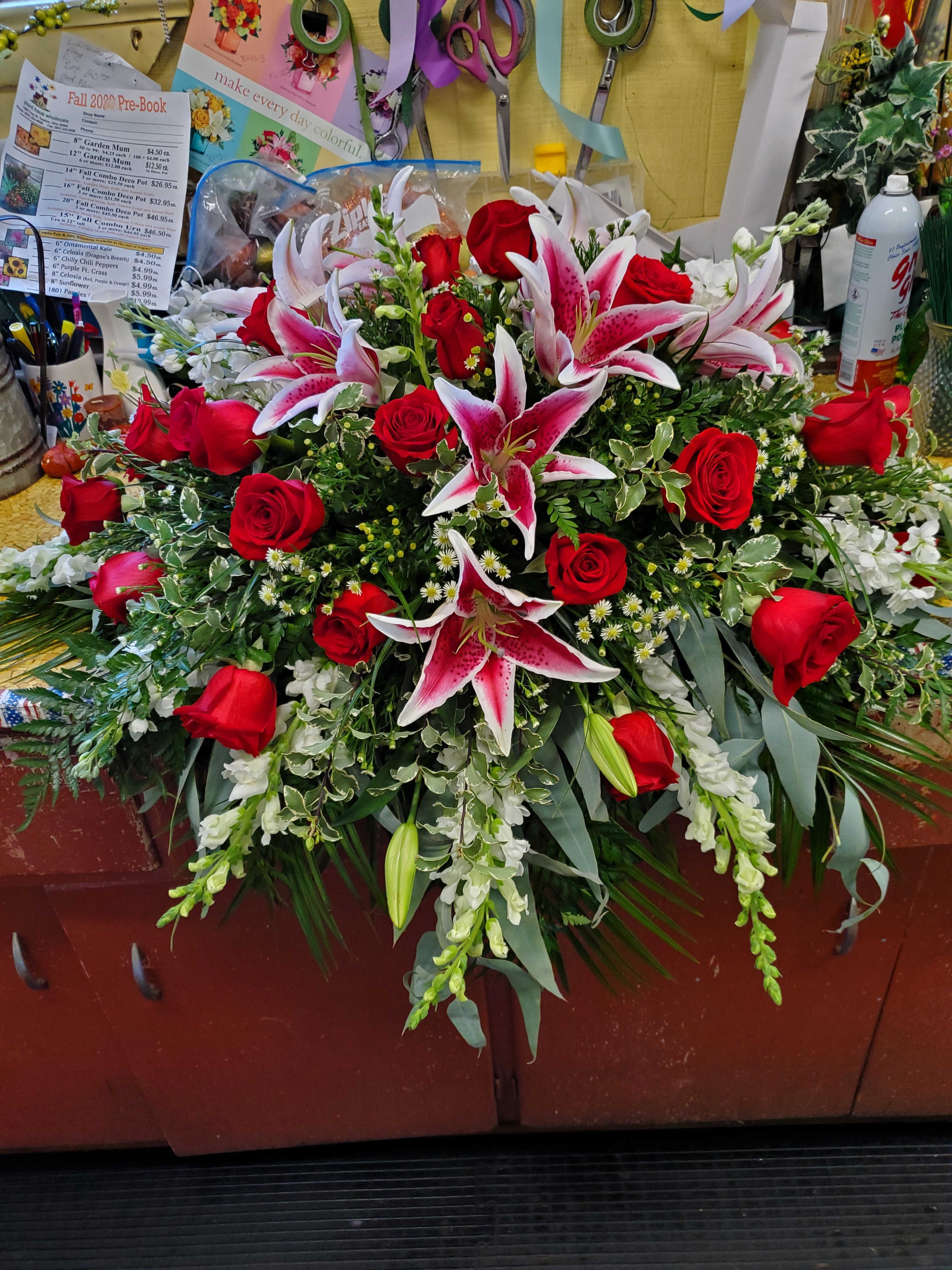 Rose and Lily Casket Spray Rose and Lily Casket Spray - Beautiful spray including Roses, Lilies, Snaps, Stock, with white Monte filler and Greens 175.00-275.00