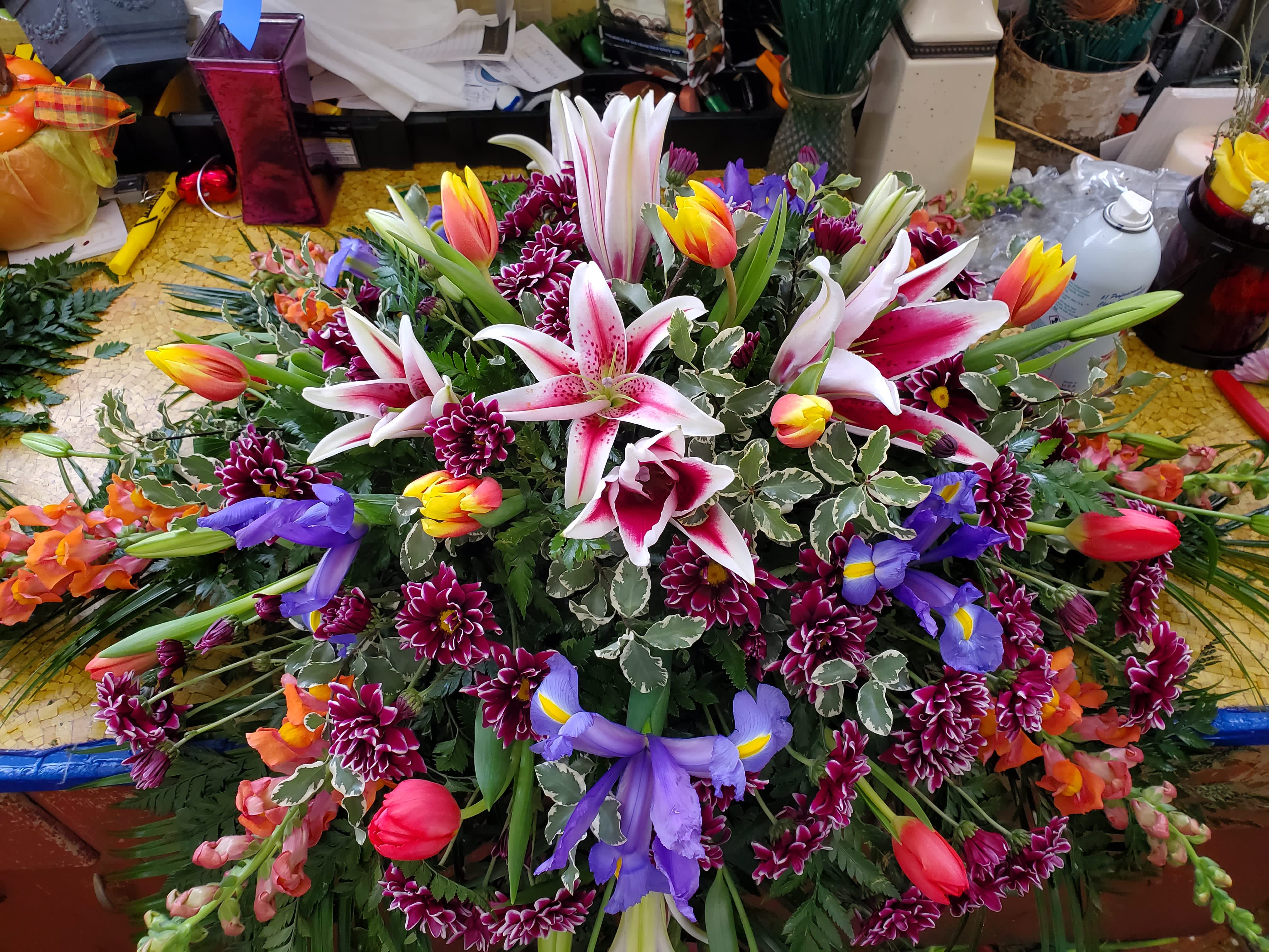 Sunrise Casket Spray - Irises, Tulips, Glads, Lilies, Daisies, with fillers and greens  200.00-275.00