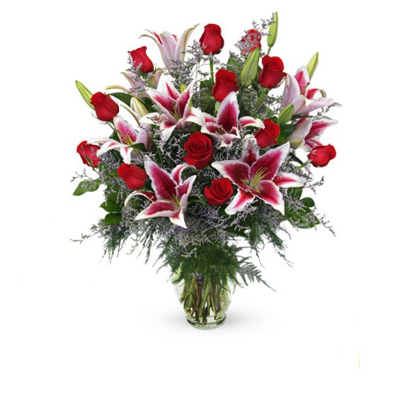 Roses &amp; Lilies - This masterful combination of floral beauty captures and conveys romantic thoughts and feelings like few arrangements can. A finely crafted glass container holds Pink lilies, red roses and fillers. Vase &amp; Color May Vary