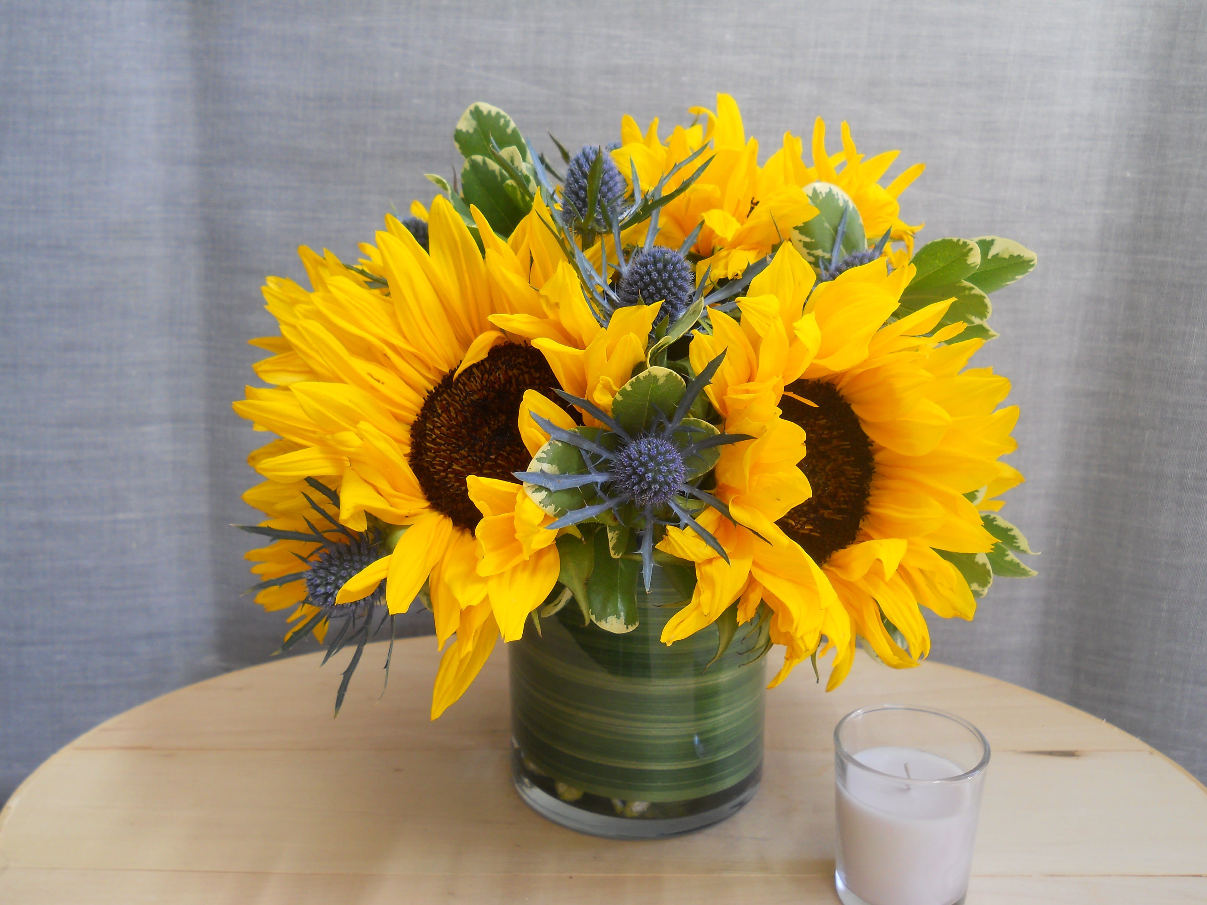 Sunflowers and Tesasel Sunflowers and Tesasel - blue teasel flowers and sunflowers in a glass base.