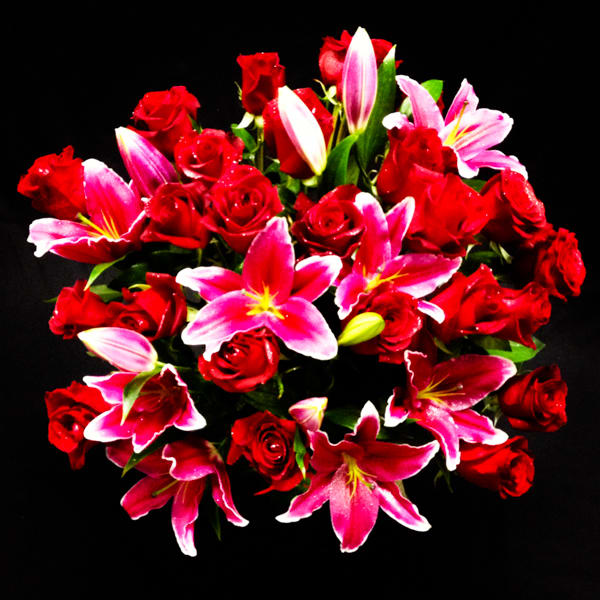 Roses &amp; Lilies - Big and Beautiful Rose Bouquet with pink lily, just to amaze your love. Perfect Valentines Day Flowers for your special person. Beautifully designed 18 Red Roses and 5 stems of Pink Lily in a Designer Choice Glass Vase. Long stem Roses and Amazing pink lily create an amazing bouquet. Anniversary wishes, Birthday Wishes or may be just because you love some one so much. Upgrade to deluxe for 18 Roses + 7 Lily and Premium for 21 Roses+ 8 Lily . Call for special Request.   Our Floral designer might discuss with you about the design or color depends on the availability of certain flowers. We promise to make the best floral design every time for your special reason. Garden of Roses is the Best Local florist in Moreno Valley and Surrounding areas. We won the Best Flower Shop Award in 2013 out of 30 florists in Inland Empire, CA. This Flower Arrangement will bring Smile to your loved ones, and we promise to provide the best Flower Delivery Service you ever have. We are not an Online Flower Delivery Services, We are real local florist! We will create a stunning bouquet and hand deliver the Arrangement on your special occasion to your special person. Send this Pretty Flower Bouquet for Anniversary Wishes, Birthday Wishes, Just Because Flowers, Thinking of You Flowers, Miss you flowers, Valentine’s Day Flowers, Mothers Day Flowers.
