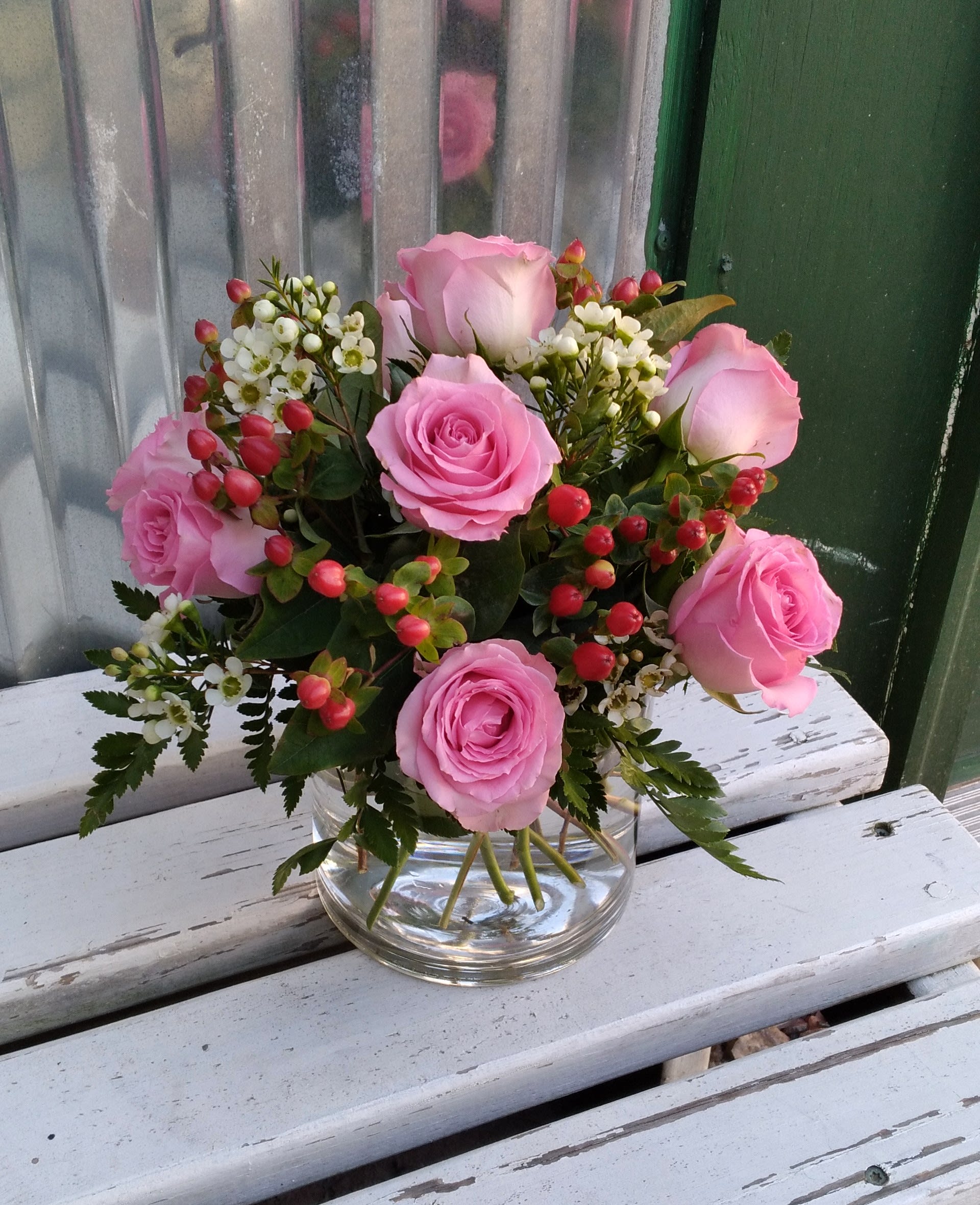 Pretty Pink with Berries Pretty Pink with Berries - Here's a pretty bouquet with "sweet unique" pink roses and red hypericum berry, kissed with a touch of fragrant wax flower filler. Gorgeous! Standard- as shown Deluxe- more flowers Premium- more flowers and larger vase