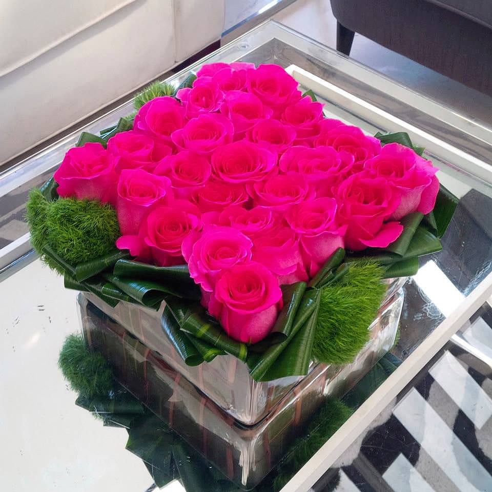 Field of Roses - Hot Pink Roses in a beautiful flat 10&quot;x10&quot; glass vase with greens. Make a request to change the color of the roses to make it perfect for any occasion.