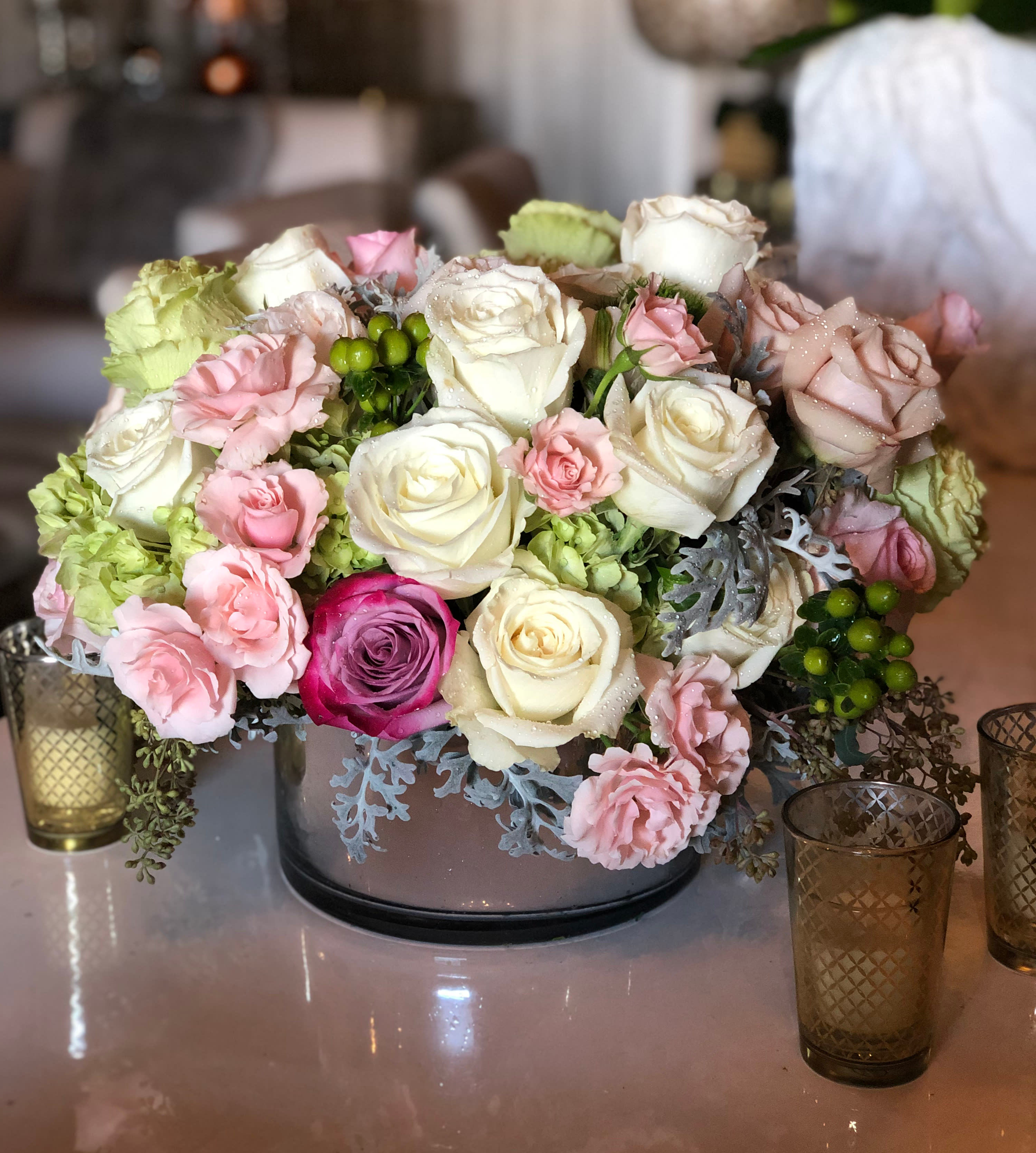 Peach Vintage - A low and lush arrangement overflowing with roses, hydrangeas, and various elegant fillers. Sitting in a 10&quot; x 4&quot; cylinder container, these florals will bring a smile an equally beautiful smile to any who see it.