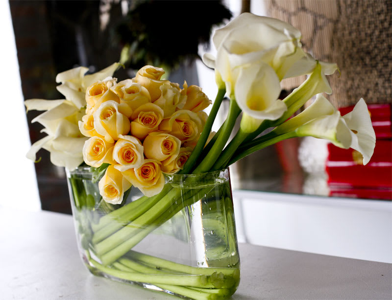Buttercream - Angular white calla lilies and champagne roses in a modern glass vase.  