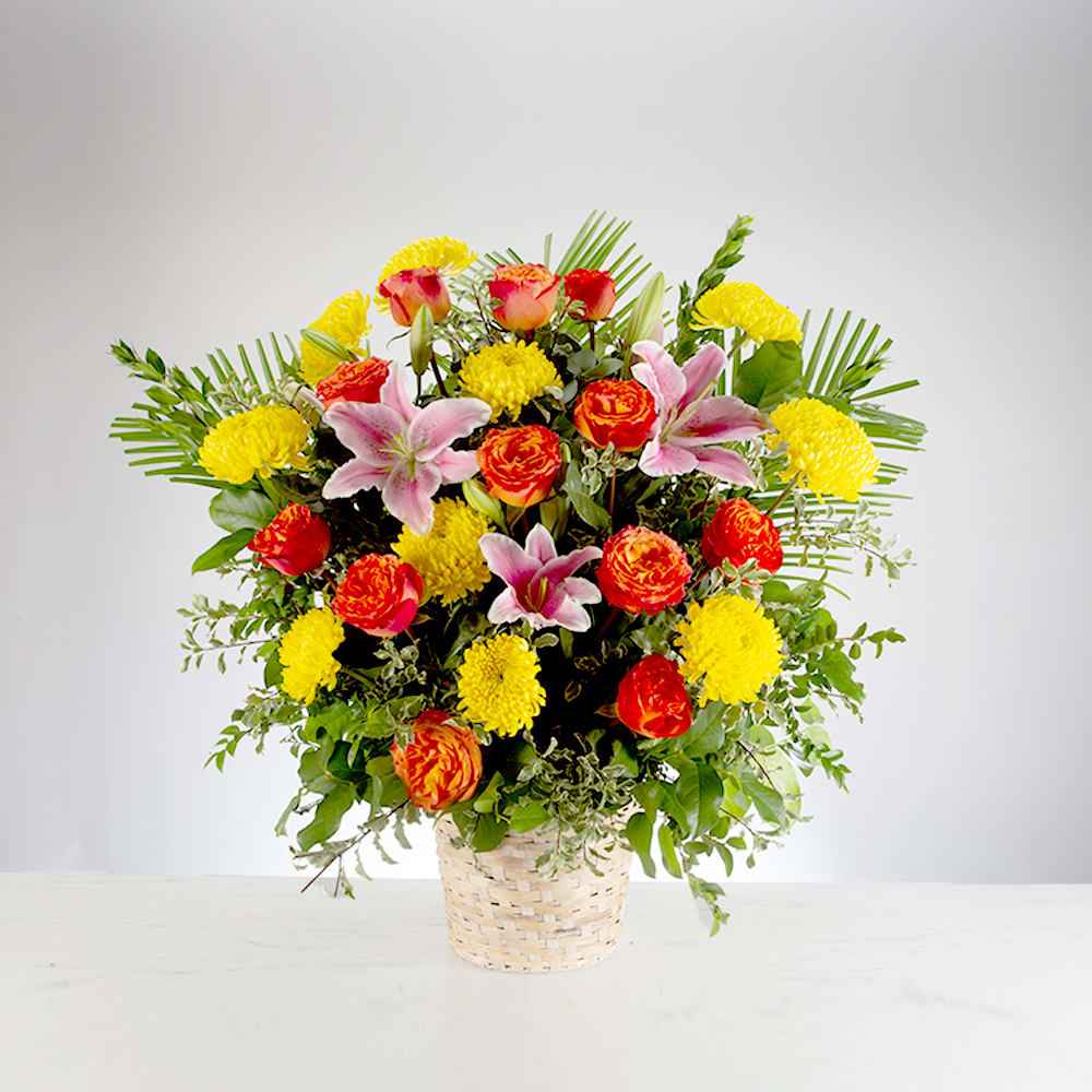 Spring Morning by BloomNation™ - This colorful and bright funeral basket is representative of a life lived to its fullest. Fitting for any type of service, colors and flowers may change based off of season and availability. 
