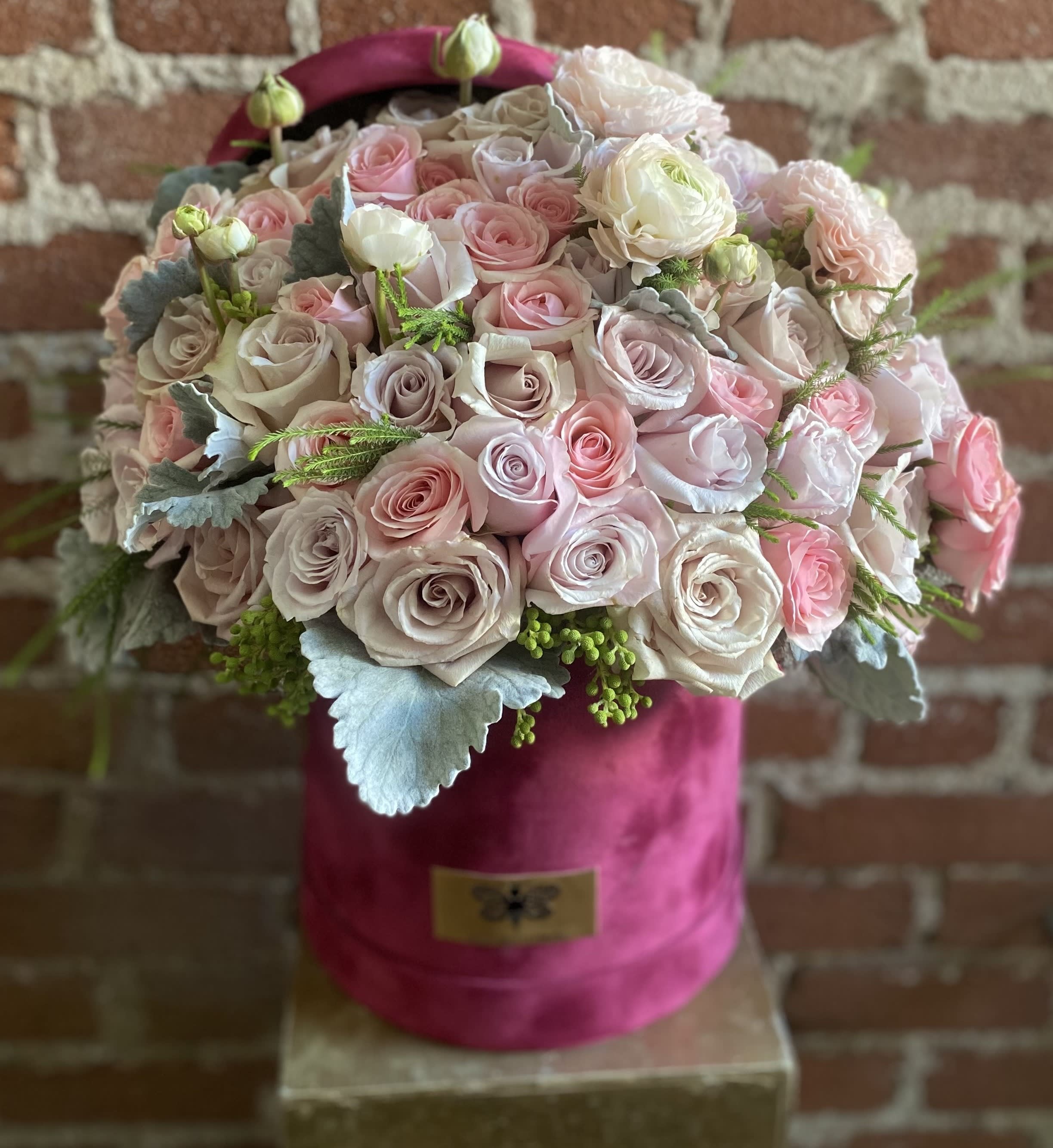 Amalfi - Buzzy Bee Flowers - Inspired by the beautiful City of Amalfi this arrangement will put a smile on a loved ones face. Filled with Pastel Colored Roses it is definitely a fan favorite and showstopper!