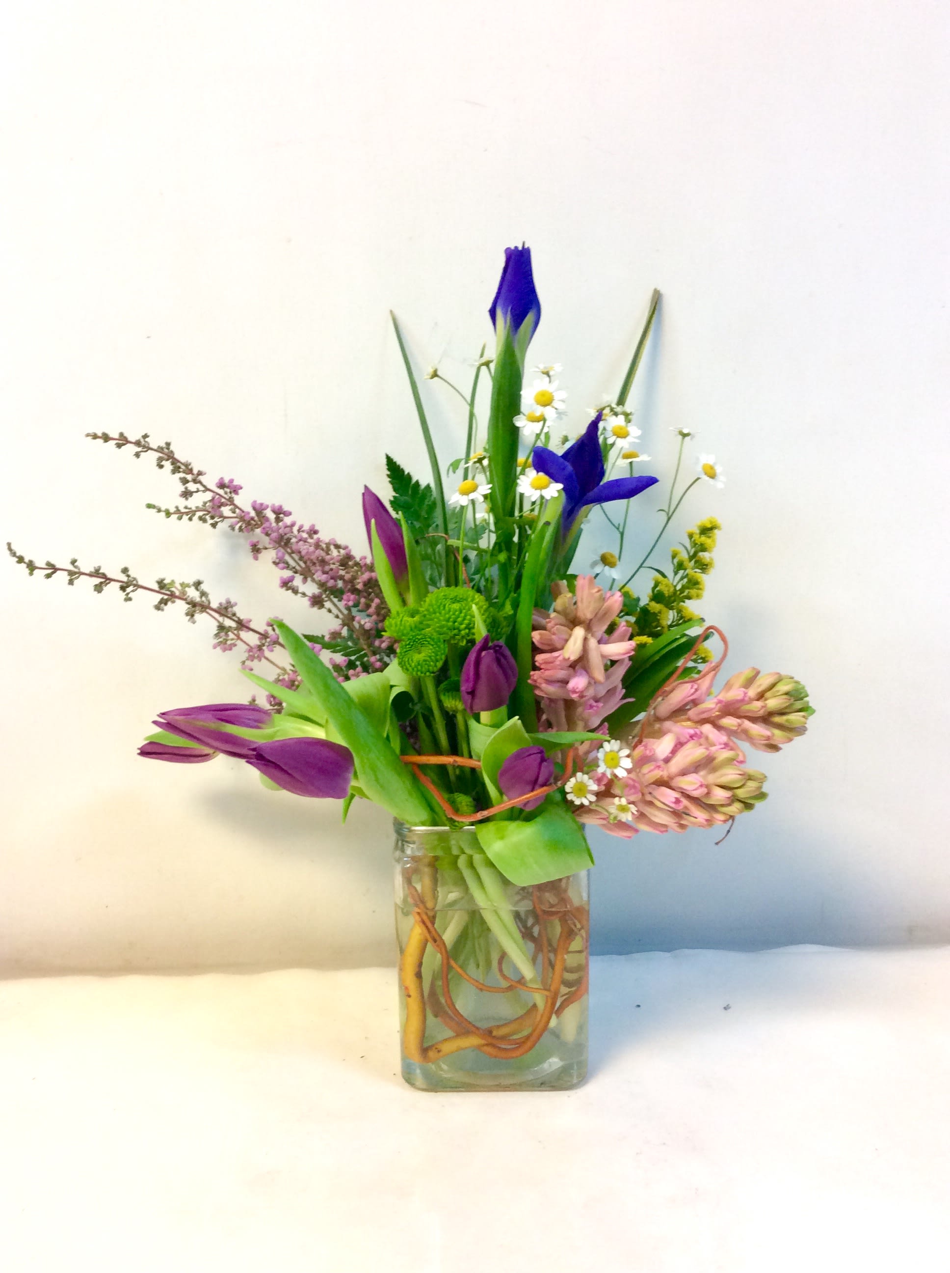 Spring Spectacular - This rectangle vase is jammed full of spring!  Hyacinth, Feverfew and Tulips in bright uplifting colors bring a refreshing smile. HFS-1055