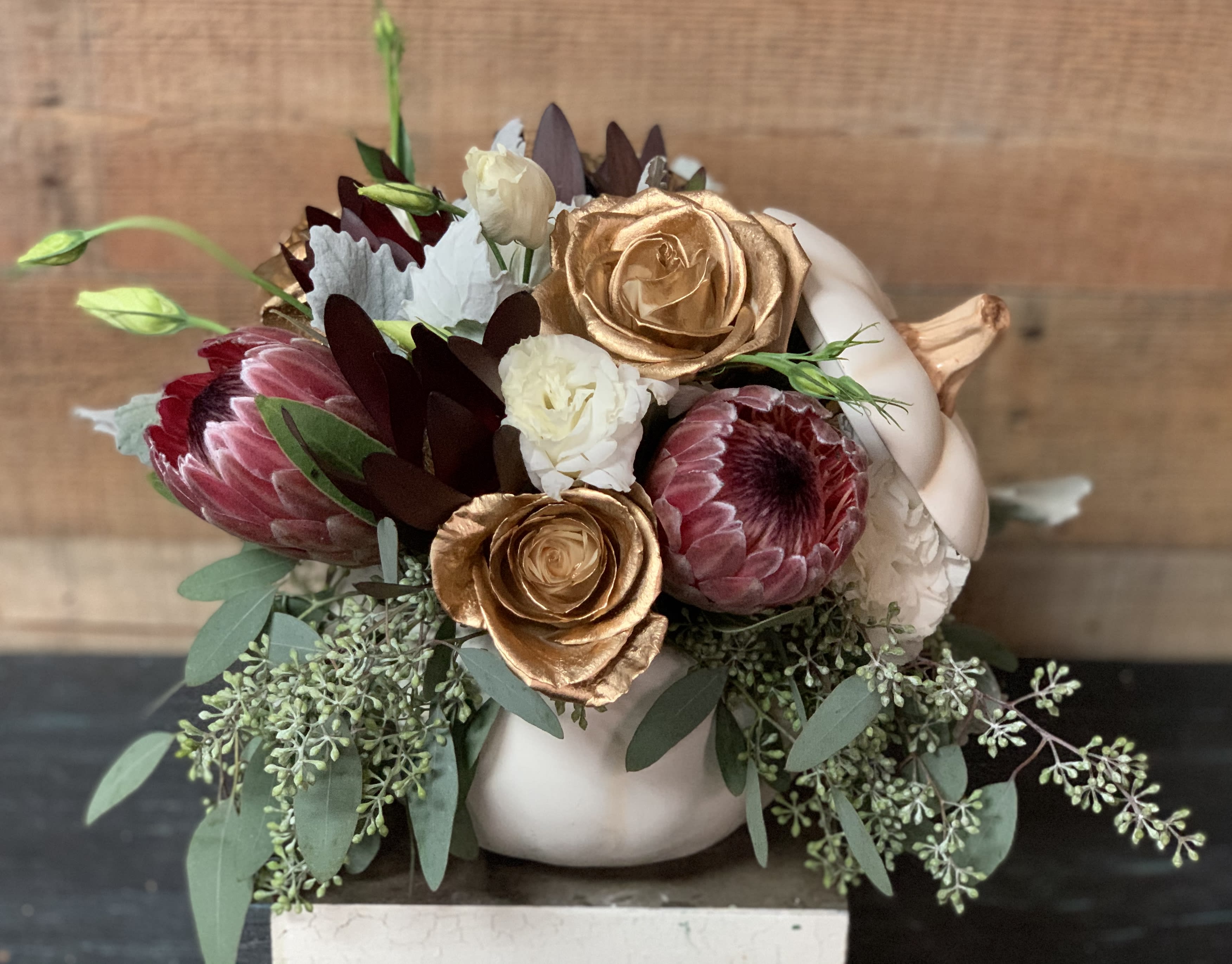 Fairy Tale Pumpkin Fairy Tale Pumpkin - Gold Roses, Proteas, lisianthus, and safari sunset in a beautiful white ceramic pumpkin. A pumpkin fit for royalty.