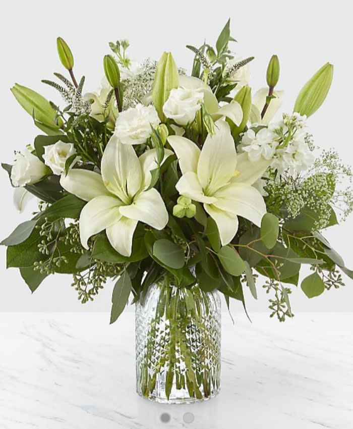 Alluring Elegance bouquet - Our Alluring Elegance Bouquet is a striking array of ivory and green. Handcrafted using Asiatic lilies interwoven with white Veronica, white stock, Queen Anne's lace, silver dollar eucalyptus and seeded eucalyptus, this bouquet graces every room with a touch of elegance. GOOD bouquet is approx. 17&quot;H x 14&quot;W. BETTER bouquet is approx. 18&quot;H x 17&quot;W. BEST bouquet is approx. 19&quot;H x 18&quot;W.