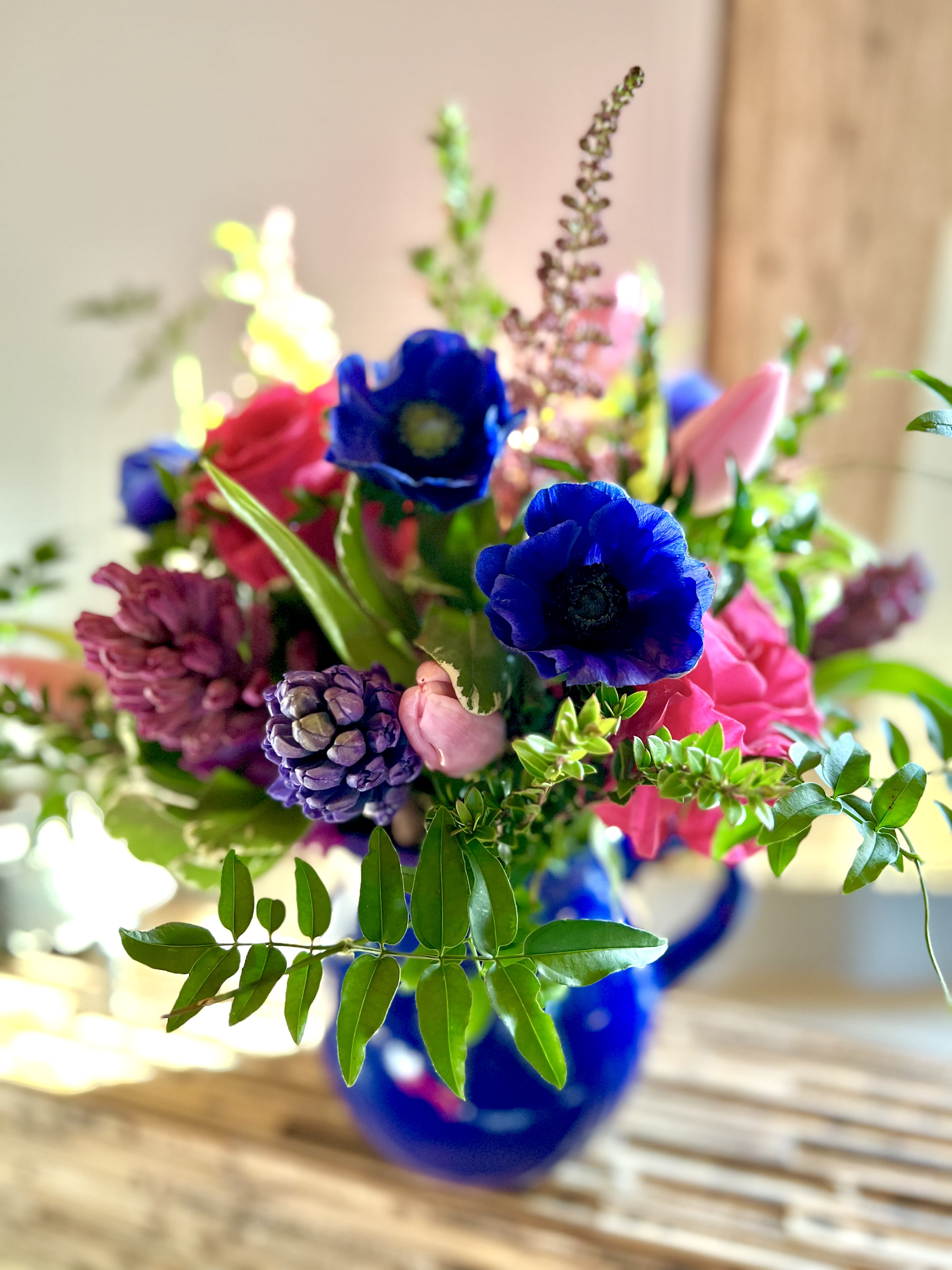 Pitcher of passion Pitcher of passion - Deep ,vibrant blooms adorn this deep blue pitcher - fragrant hyacinth ,deep blue anenome and vibrant hot pink roses
