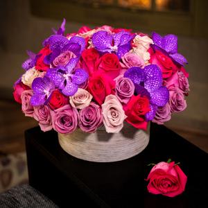 Candy Kisses - This luxury arrangement  is in a classy marble vase that includes seventy five mixed roses and exotic Vanda orchids. Its sweet and sensual like &quot;Candy Kisses&quot;.