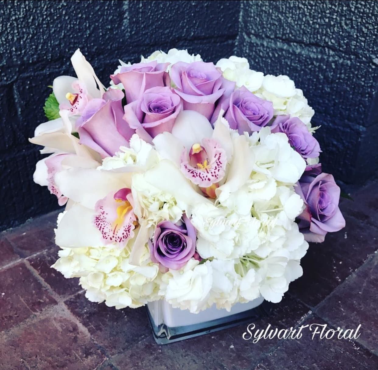 Forever Mine! Forever Mine! - White hydrangeas with a touch of roses and orchids. (Florals and container might vary due to availability.) Note: If you would like to change floral color, please add your request in the note section when placing your order.