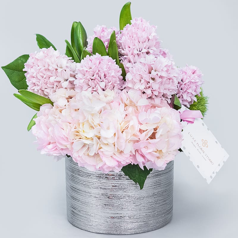 Fragrantly Fabulous - Pink hyacinth and hydrangeas in a modern silver vase. 