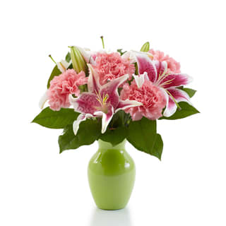 Perfectly Pink - Product ID: BF57-11KS   With its undeniably graceful pink lilies and pink carnations, this striking arrangement in a lovely green vase reaches the height of colorful perfection. Measures 11âH by 10âL.  