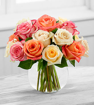 The FTD® Sundance™ Rose Bouquet - E9-4817S  The Sundance™ Rose Bouquet by FTD® employs a soft assortment of roses to create a sweet and stunning arrangement. Cream, white, orange and pink roses are simply brought together in a clear glass bubble bowl vase to make an exquisite flower bouquet set to warm their heart when extending your warmest wishes for their birthday or just to say thinking of you.