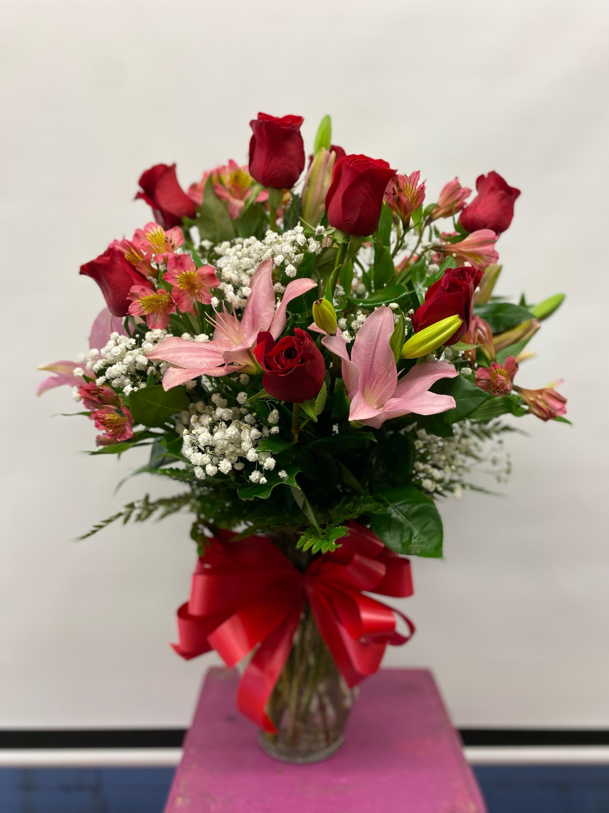 roses and lily's for you roses and lily's for you - 12 beautiful red roses with asiatic lily's and Peruvian lily's accented with baby's breath in a nice vase.