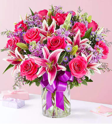 Straight from the Heart - A gift means so much more when it’s straight from the heart. Our stunning Valentine’s bouquet of passionate pinks and purples is expertly arranged inside a glass cylinder vase and wrapped in a purple satin ribbon for the perfect finishing touch. It’s a romantic surprise that speaks volumes about the love you feel.