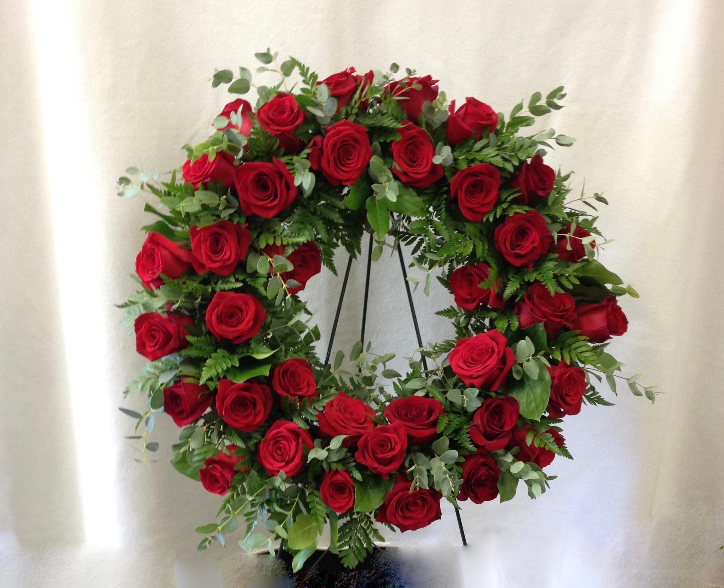 Circle of Love Wreath Circle of Love Wreath - A true tribute of love and affection. This beautiful wreath has beautiful red roses (or a color of your choosing) and assorted greenery.