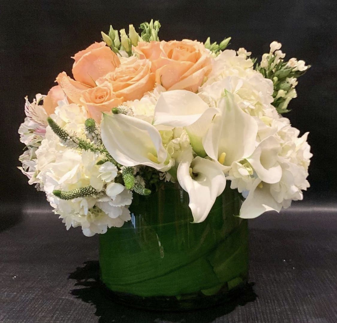 Custom Arrangement of white hydrangea white calla lilies, alstroemeria &amp; roses - Custom Arrangement of white hydrangea white calla lilies, alstroemeria, lisianthus, roses &amp; Bells of Ireland in clear glass cylinder with leaf wrap.