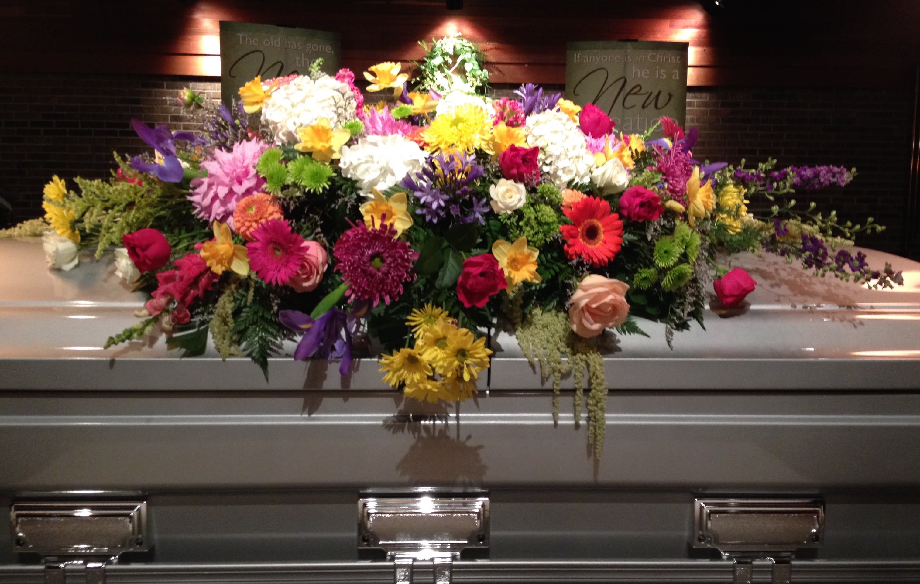  Always Adored Casket Spray - A beautiful garden spray will ease the burden of loss. A mix of gorgeous blooms and colors for a closed casket.      