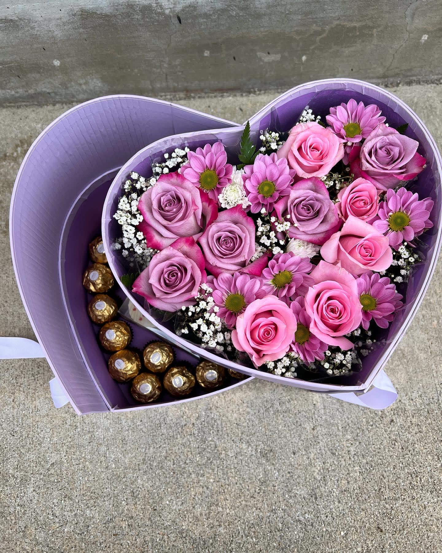 Double heart box - Two layer box, the bottom is chocolate and the top is filled with flowers in pink and purple color.