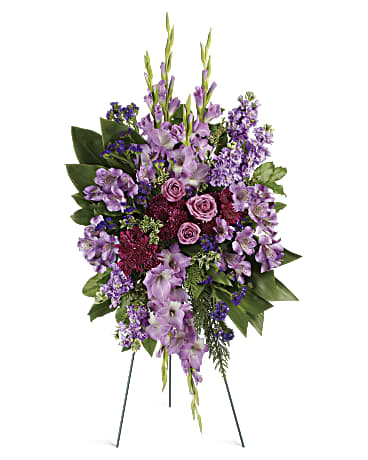 Lavender Reflections Spray -  Take a walk through the garden of memories with this lush spray of lavender and purple blooms, accented with fresh green ti leaves. It's a joyful expression of sympathy sure to be appreciated.      This regal spray includes lavender roses, lavender alstroemeria, lavender gladioli, lavender stock, purple cushion spray chrysanthemums, purple sinuata statice, green ti leaves, flat cedar, oregonia and lemon leaf.     Orientation: One-Sided 