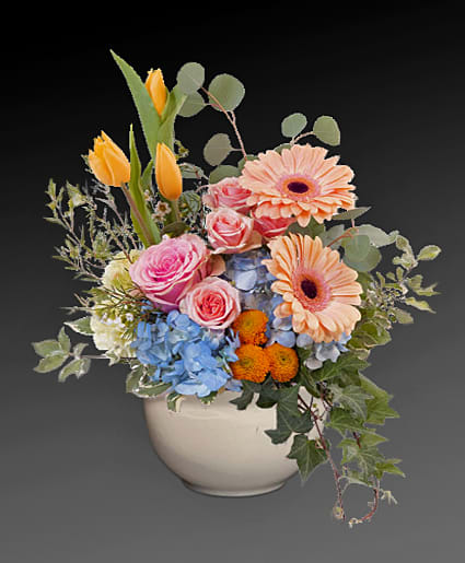 Happy Spring - Talk about a bright idea! This cheerful bouquet of pink roses and peach gerberas brings joy to any occasion--especially since the lucky recipient gets to keep the chic mid-century ceramic planter!