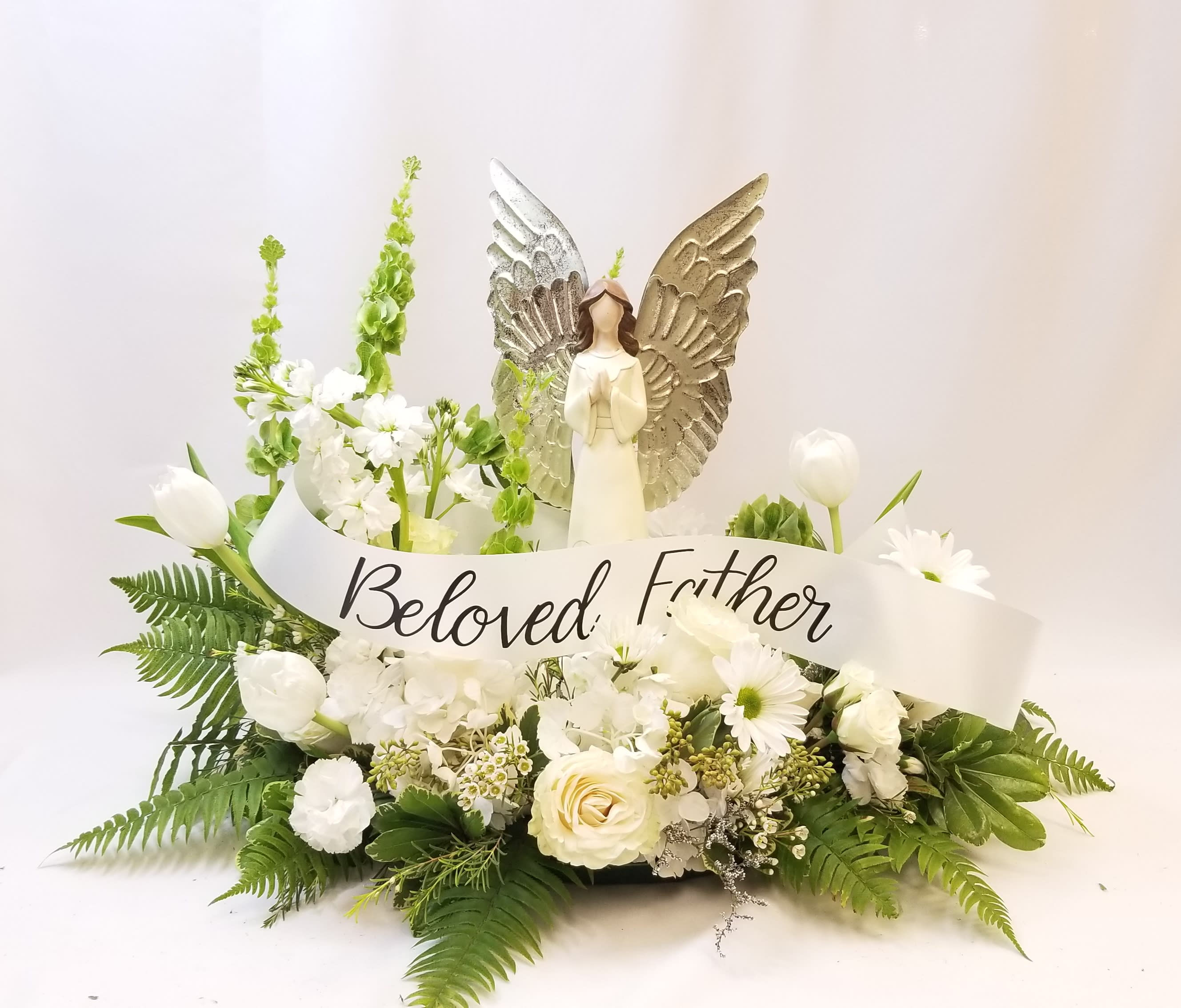 Tears In Heaven Tears In Heaven - Delicate blooms in whites and ivories call to mind beauty, and sweetness. Express your sincerest sympathies with our graceful arrangement. Soothing white roses, stock, cremones and more are loosely gathered with fresh lush greenery. It’s a comforting and beautiful gesture that will honor a life so beautifully lived. • Arrangement of white roses, stock, snapdragons, larkspurs, alstroemeria, spray roses, waxflower and white Asiatic lilies and daisy poms; accented with fresh greenery • Artistically designed by our florist we can customize this arrangement to different colors but they will be subject to local availability. **PREMIUM Version shown with angel and customized ribbon We proudly serve and deliver fresh flowers everyday to Deland, Deltona, Orange City, Debary, Lake Helen, Cassadaga, De Leon Spring, Sanford, Lake Mary, Daytona Beach and many other surrounding areas.