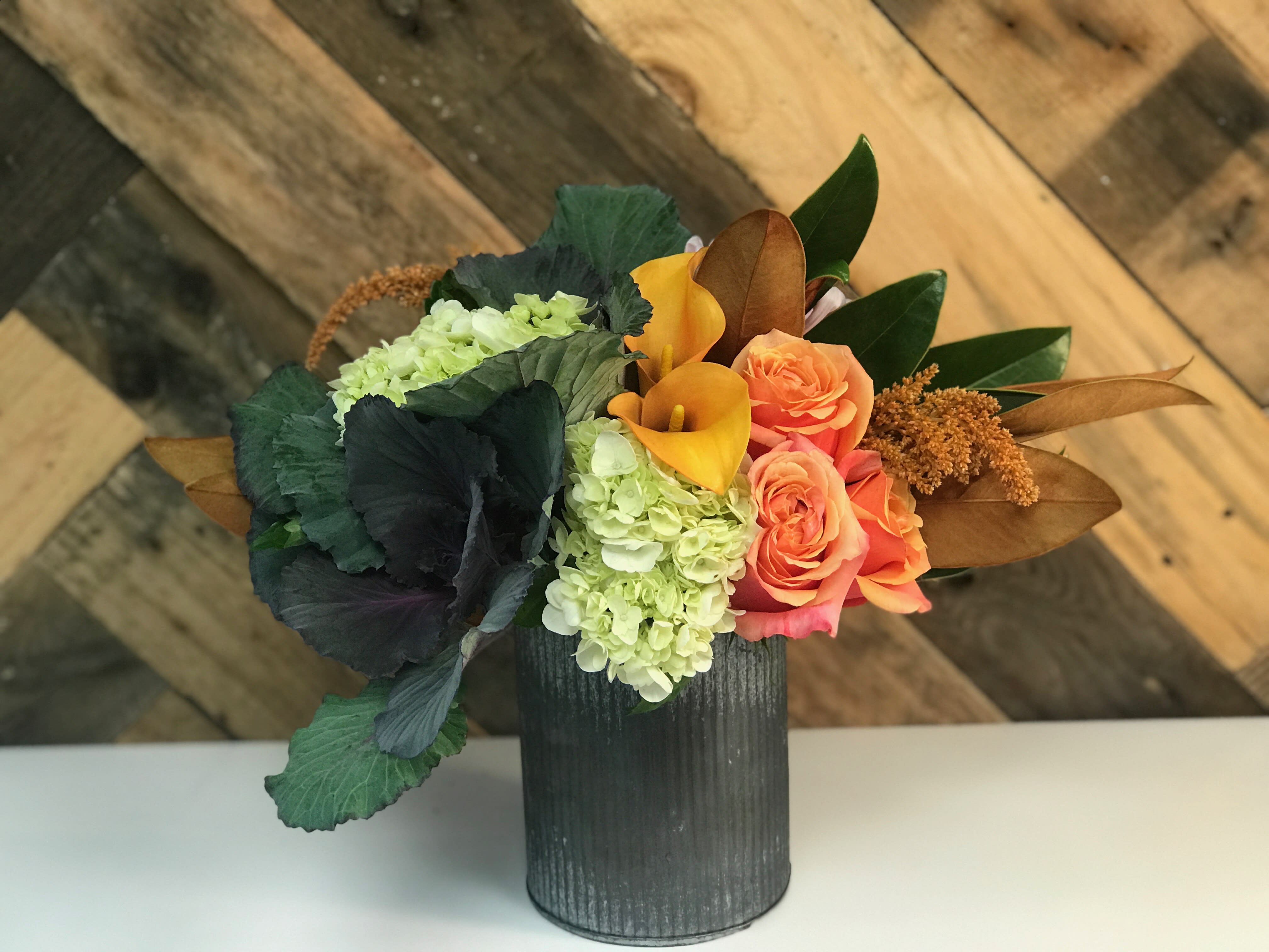 Designer's Choice Seasonal Bright (Fall) - Our Designer's Choice Seasonal Bright (Fall) arrangement is bright and fun. We hand select our flowers and natural elements with a focus on American Grown flowers. This arrangement features blooms in brighter colors and is accented with seasonal greens designed in a complementing ceramic or metal vase. This arrangement is perfect as a birthday gift or as a festive centerpiece for any autumnal gathering or celebration.