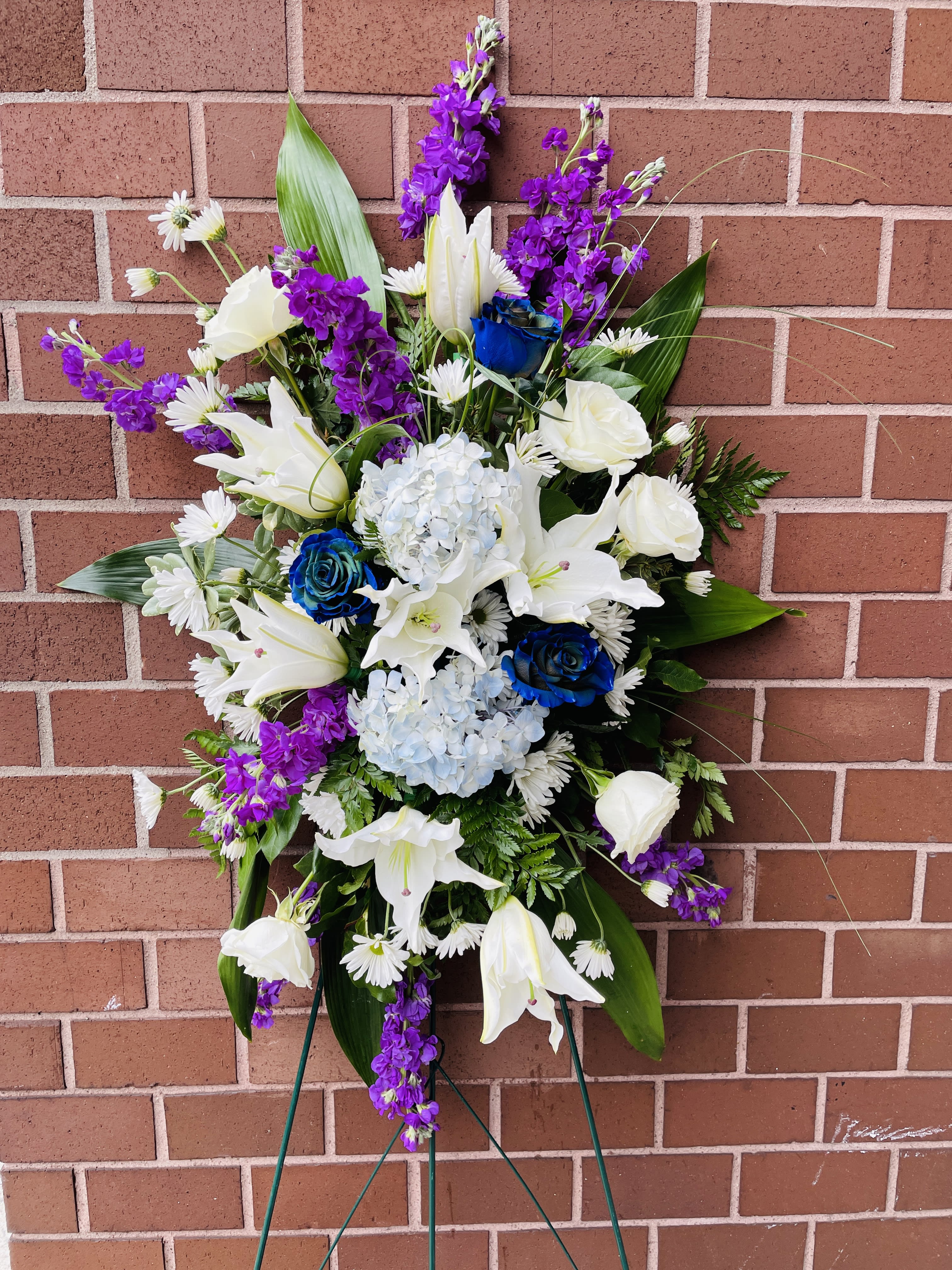 Celebrate your loved one's life with this radiant arrangement of purples and white blooms. Celebrate your loved one's life with this radiant arrangement of purples and white blooms. - Flowers can include fragrant lilies, stock, carnations, roses, liatris, and beautiful tones of purple, lavender, and white