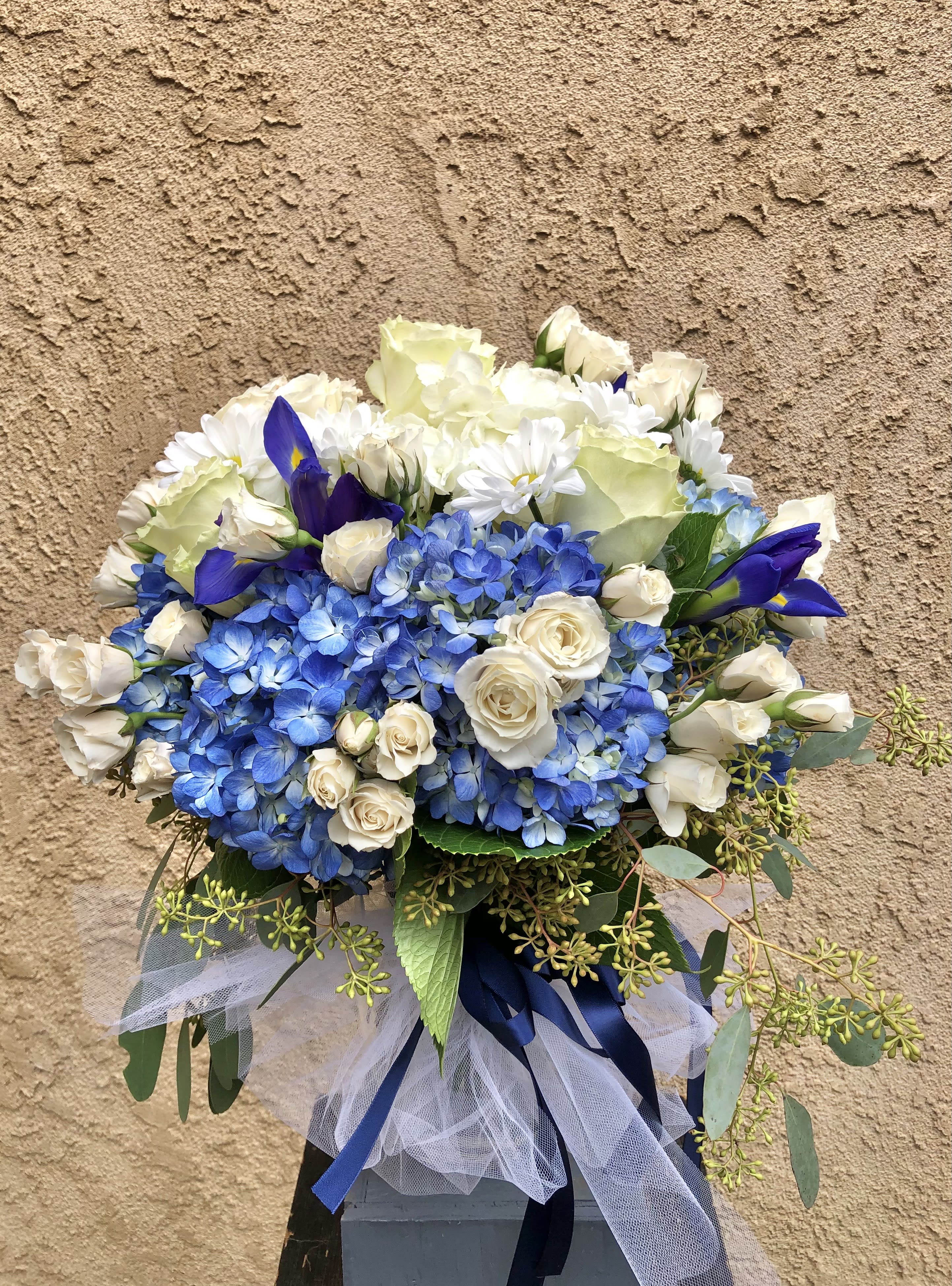 Healing Air - Beautiful blue and white arrangment featuring hydrangeas, iris, roses, daisies, and green accents.