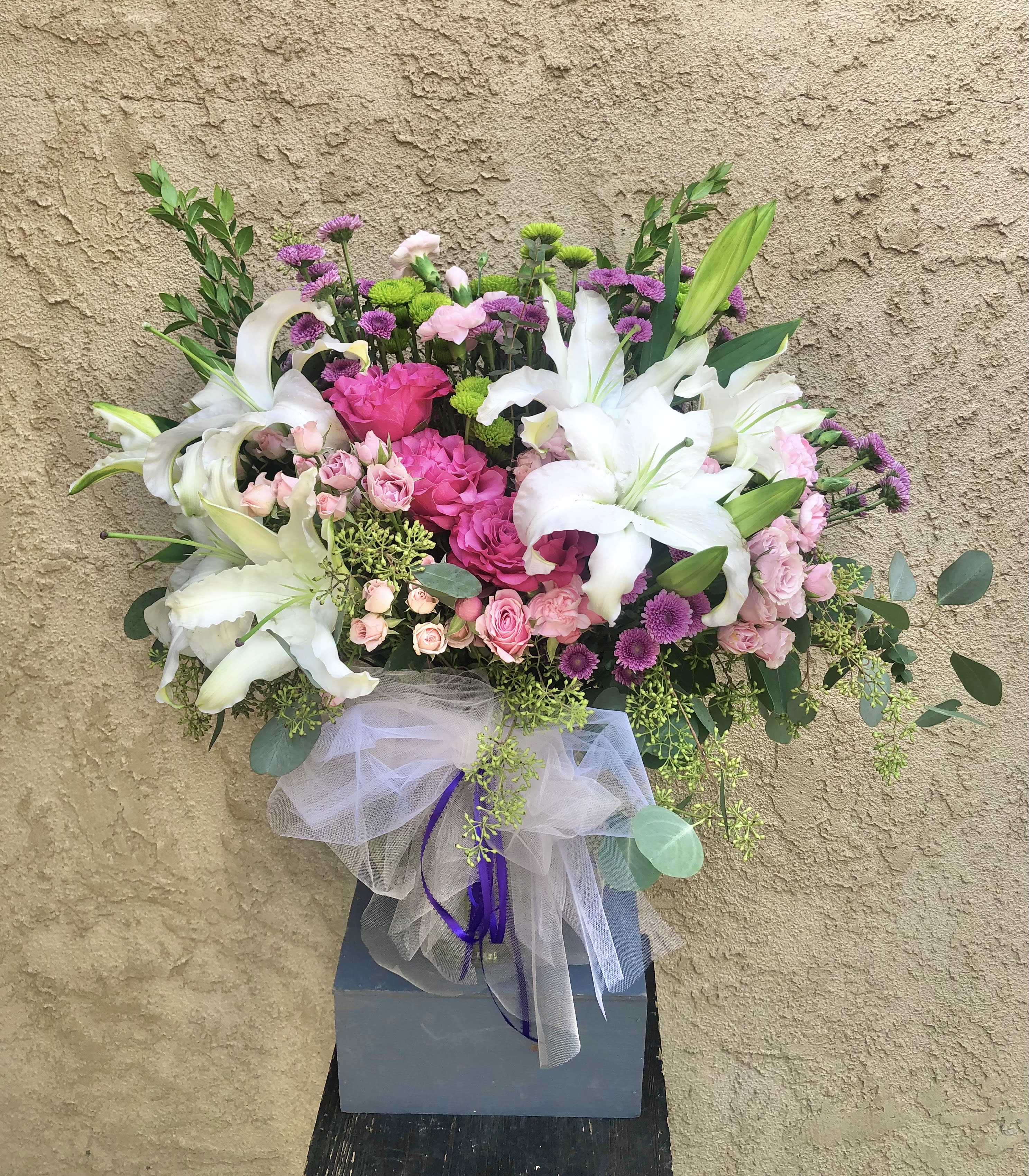Garden of Love - Beautiful arrangment featuring mums, lilies, roses, carnations, and green accents 