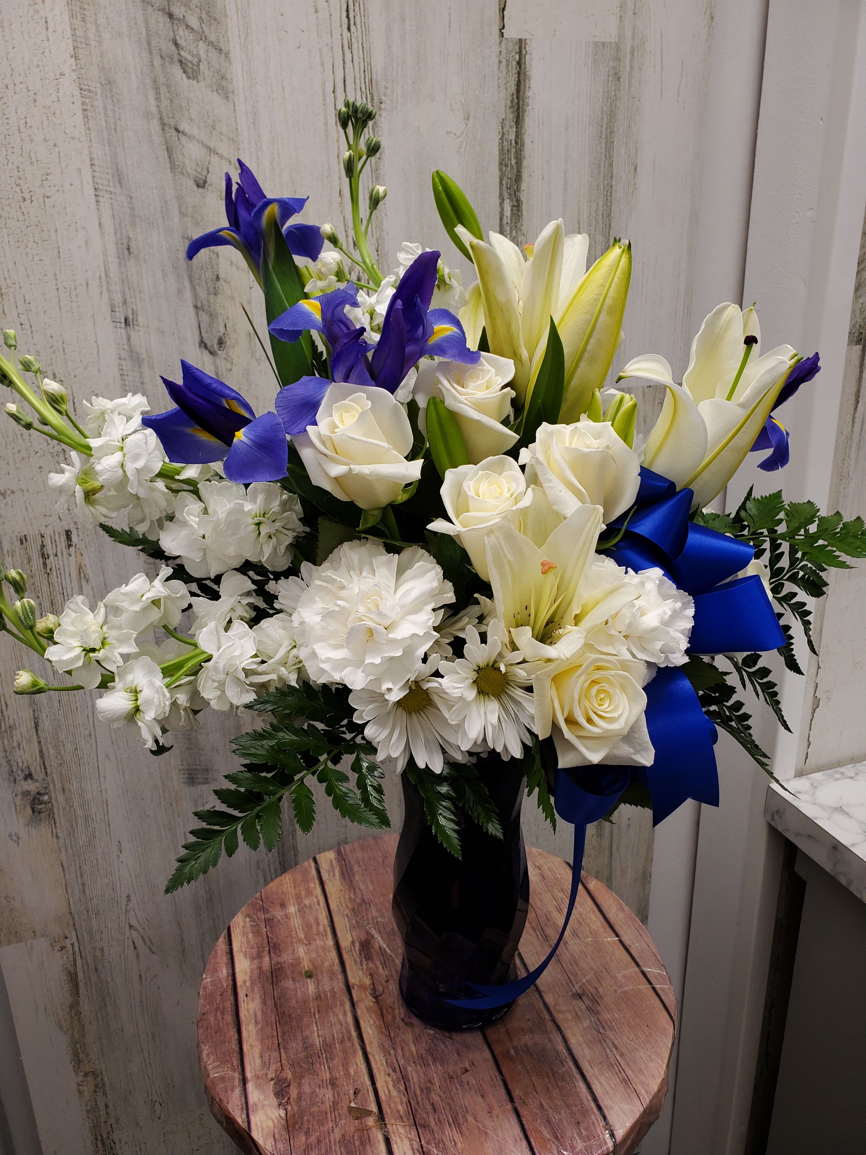 Becky - As open and bright as a winter's sky, this exquisite mix of white and blue blossoms would make a stunning birthday gift, or a superb Hanukah present for a favorite friend or family member. An eye-catching selection. 