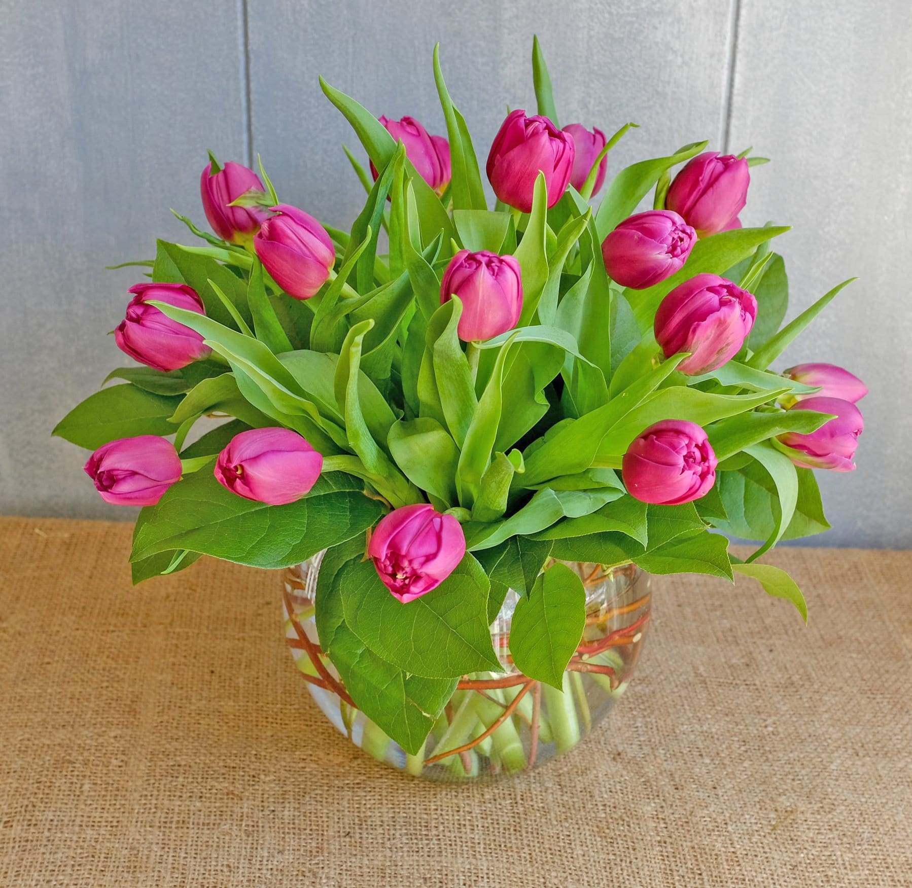 Tulips in a Bubble - Tulip blossoms are a sure sign that Spring is on its way. Send this beautiful bouquet of fresh assorted tulips, hand-arranged in a bubble bowl, and bring the timeless beauty of the season to their door. Abundant bouquet of the freshest tulips in assorted colors Hand-designed by our expert florists in a classic clear bubble glass vase tied with raffia; vase measures 6&quot;H Arrangement measures approximately 17&quot;H x 16&quot;W with 15 tulips Our florists hand-design each arrangement, so colors, varieties, and container may vary due to local availability 