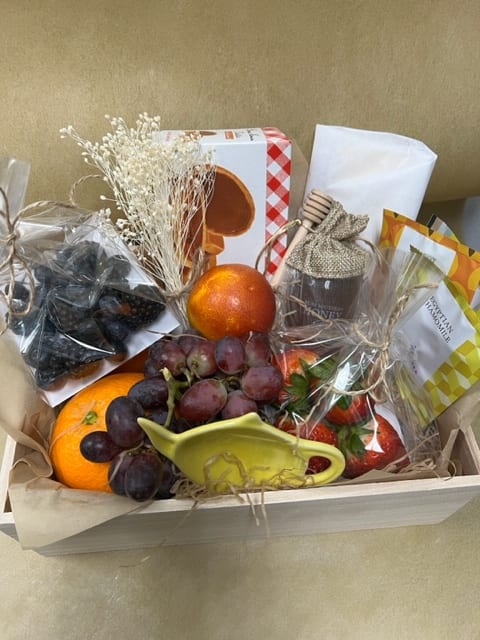 Gourmet Fruit Box Gourmet Fruit Box - A gift basket filled with seasonal fresh fruits, cheese, crackers, honey, sweet tartlets, some of our bestselling tea in ecofriendly sachets, and some cute tea accessories