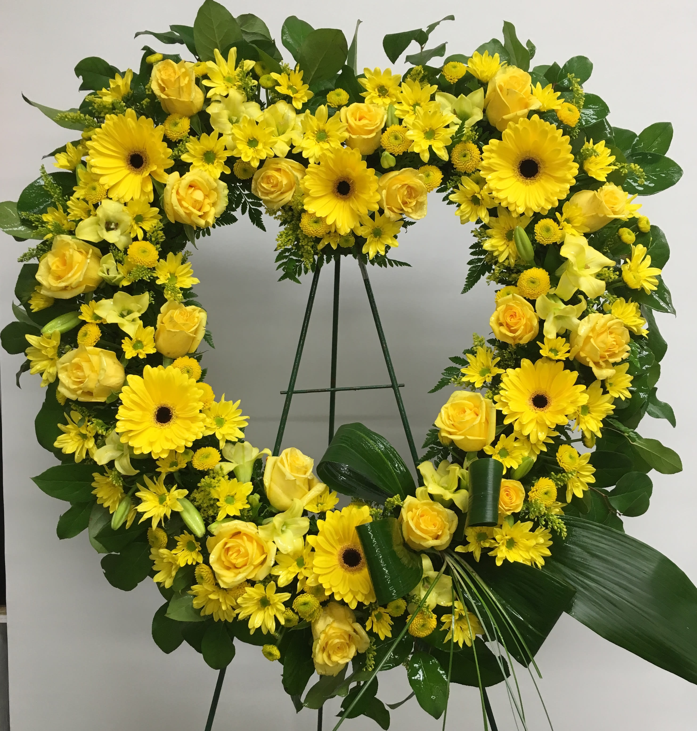Off To Brighter Skies Off To Brighter Skies - A yellow heart to show friendship and sympathy for your loved one. Yellow roses, yellow gerberas, and daisies.
