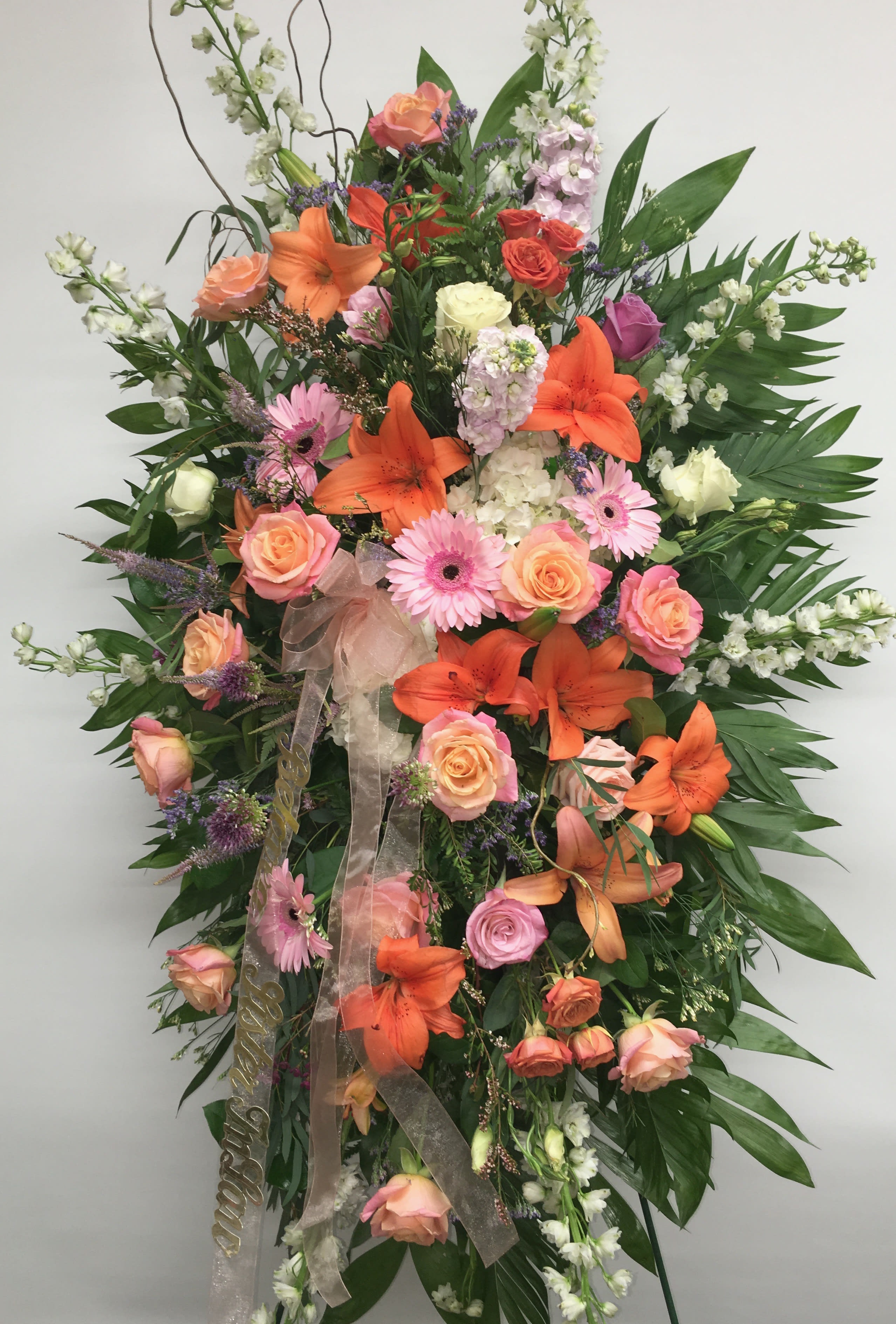 Exquisite Tribute Exquisite Tribute - Standing Spray is an elegant display of sweet serenity.
