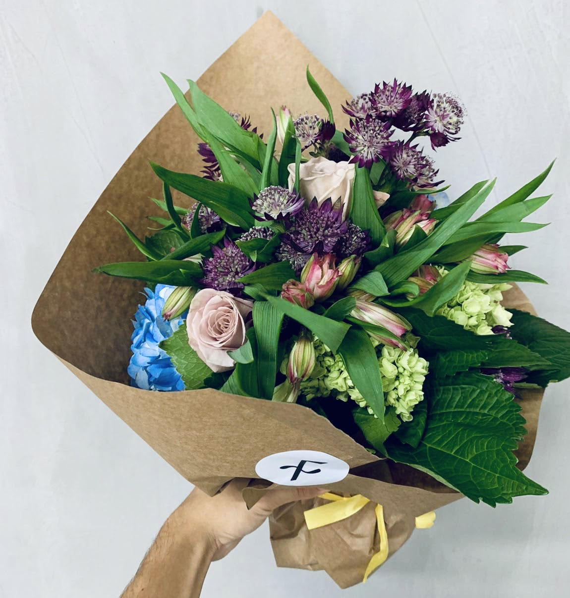 Silvestre bouquet - Just picked blooms arranged together in a bouquet featuring astrantia, alstromeria, blue hydrangea and roses