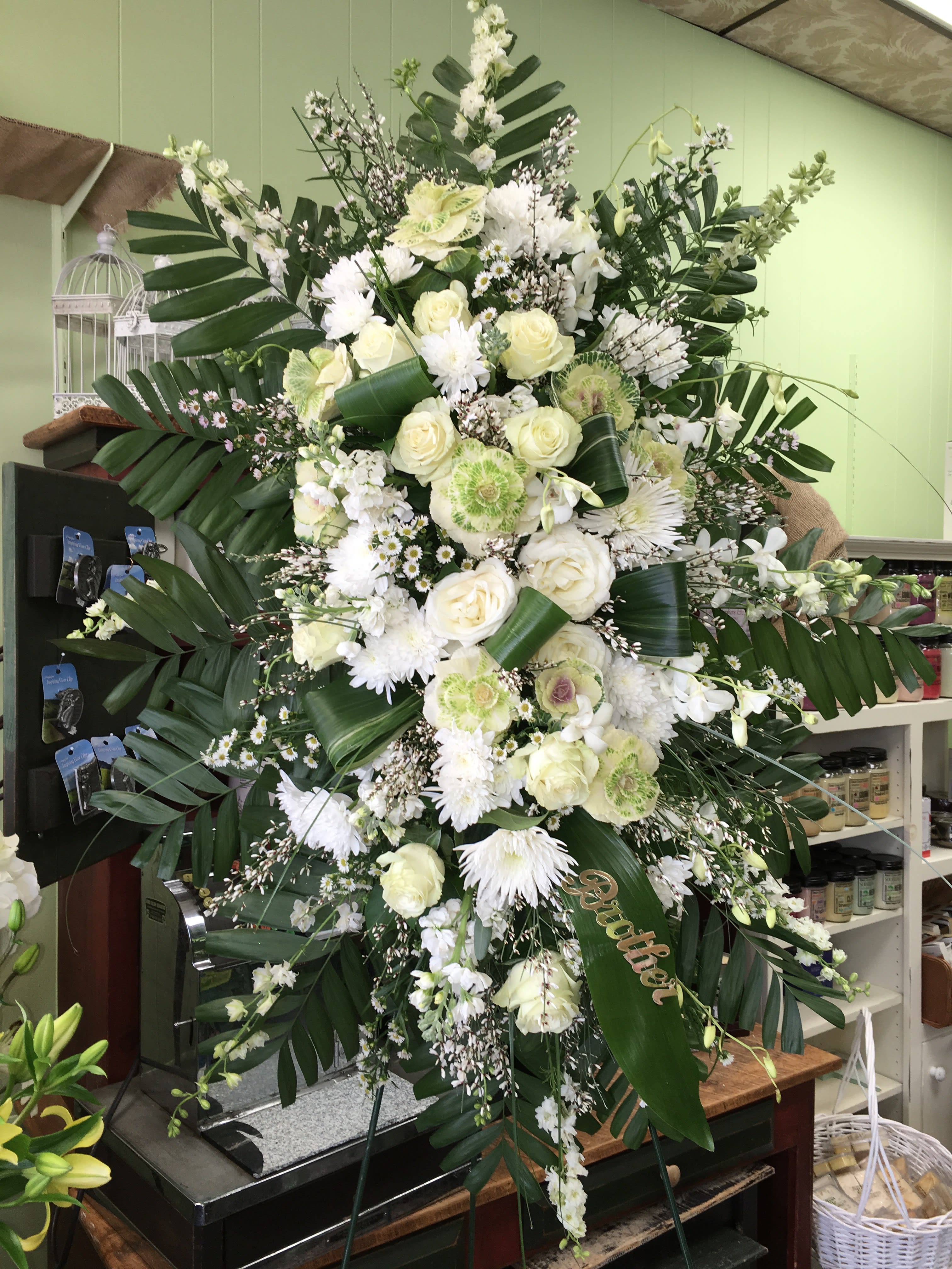 Empathy Empathy - A gorgeous, traditional spray with a pure white focal point consisting of roses, and other accents.