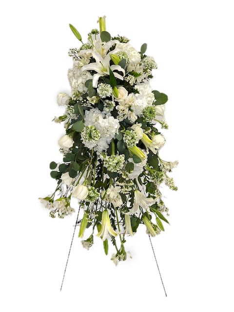 Graceful Memories Spray - A cascading easel spray featuring elegant white blooms of lilies, roses, fragrant stock. pompon ranunculus, alstroemeria, roses, spray roses, and delicate waxflower, designed with mixed foliage including eucalyptus and myrtle. Delivered on an easel. Perfect for memorial services and celebration of life. 