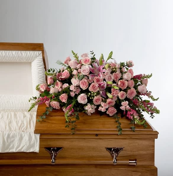 Tender Heart by BloomNation™  - Roses, lilies, and more come together for a blushing pink half casket spray. Sized to fit both open and closed caskets. 