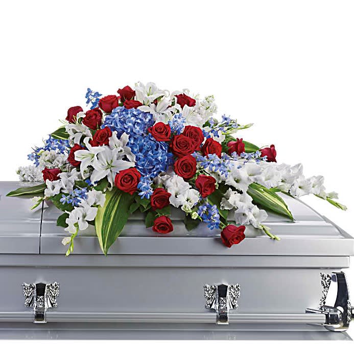 Honor and Glory Casket Spray - For the Service Honor and Glory Casket Spray - For the Service - For a military or private funeral, this classic casket spray is a proud and patriotic way to pay lasting tribute to a loved one's esteemed memory, life of service and dedication to freedom. Bold flowers such as blue hydrangea and delphinium, classic red roses, and white oriental lilies and gladioli form an all-American display honoring the deceased and their love of country.
