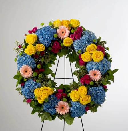 Vivid Spring by BloomNation™  - This colorful and bright wreath spray is representative of a life lived to its fullest. Colors and Flowers may change based off of season and availability. 