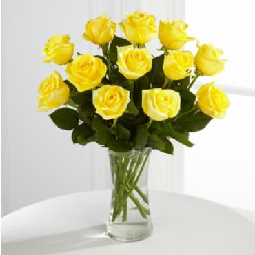 A Perfect Yellow Dozen - The classic dozen yellow rose bouquet is the perfect gift to send any time of the year. Arranged in a class glass vase.  