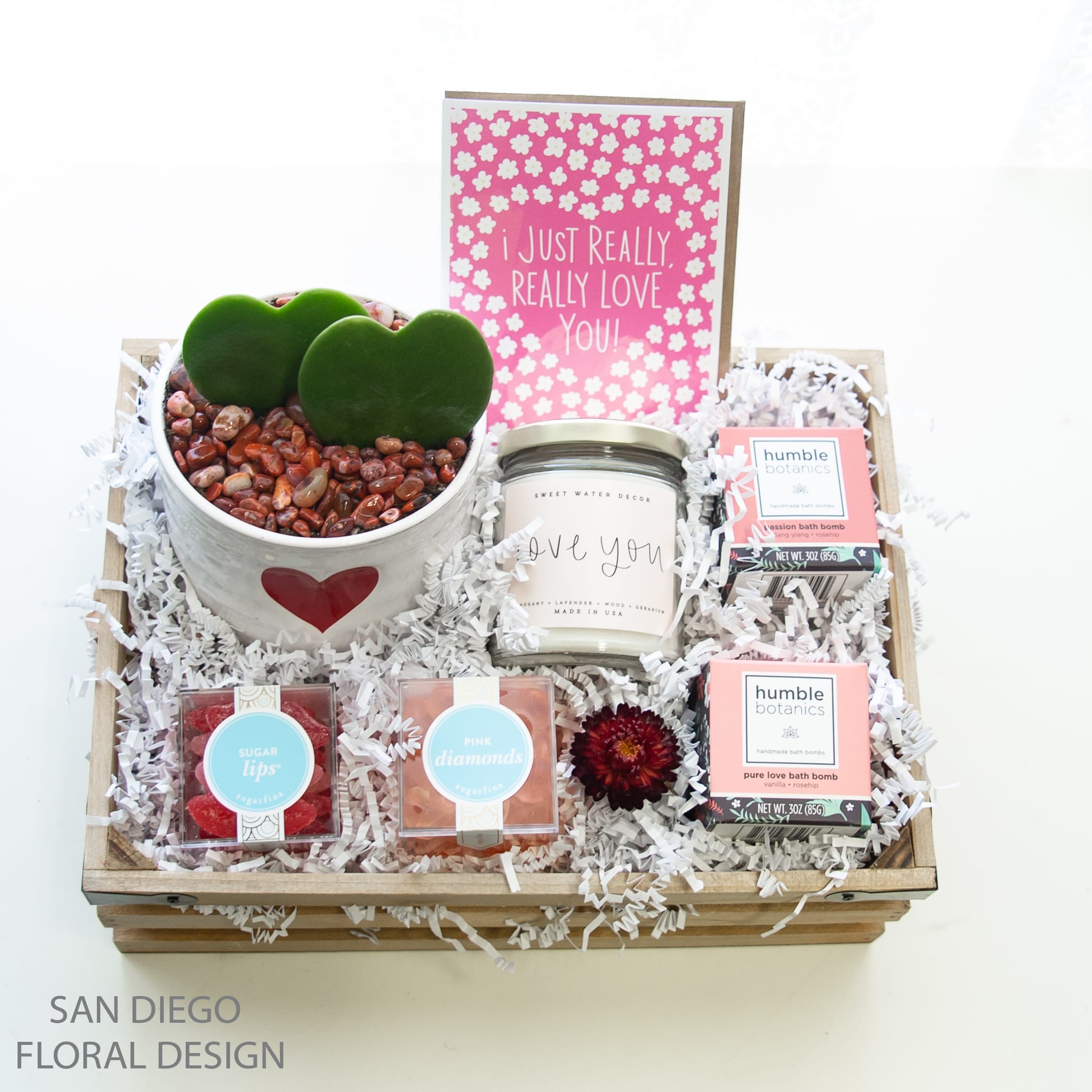 Two Of Hearts Gift Crate  - two sweetheart hoys succulents planted in a heart planter, an &quot;I Love You&quot; soy wax candle, two organic bath bombs &quot; Pure Love &quot; and &quot;Passion&quot; , two candy boxes by Sugarfina &quot; Hot Lips&quot; and &quot;Pink Diamonds&quot; and a Valentine's Day card 
