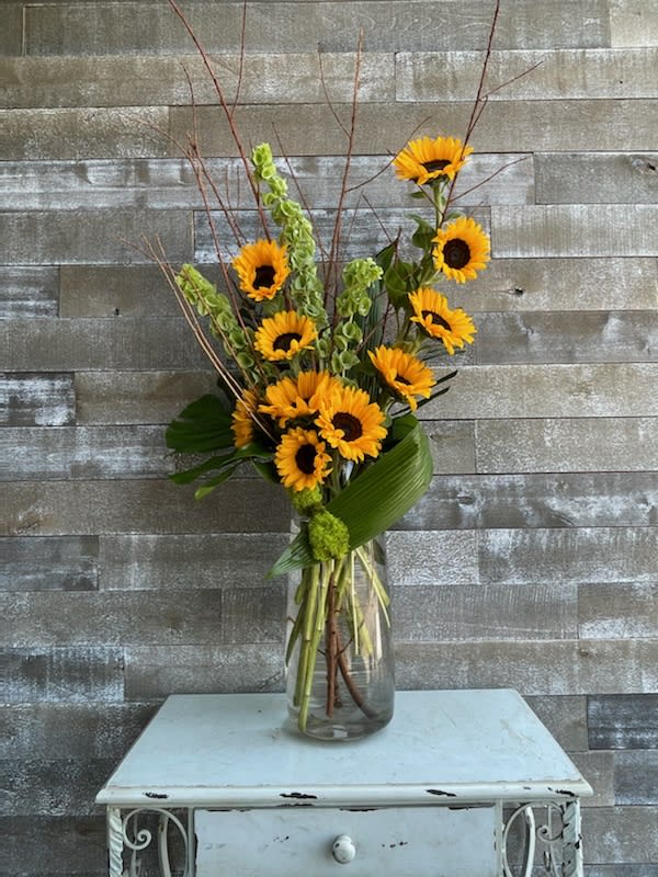 The Funflower Sunflower - Sunflowers and greens in a contemporary fresh clean display in a clear glass carafe 