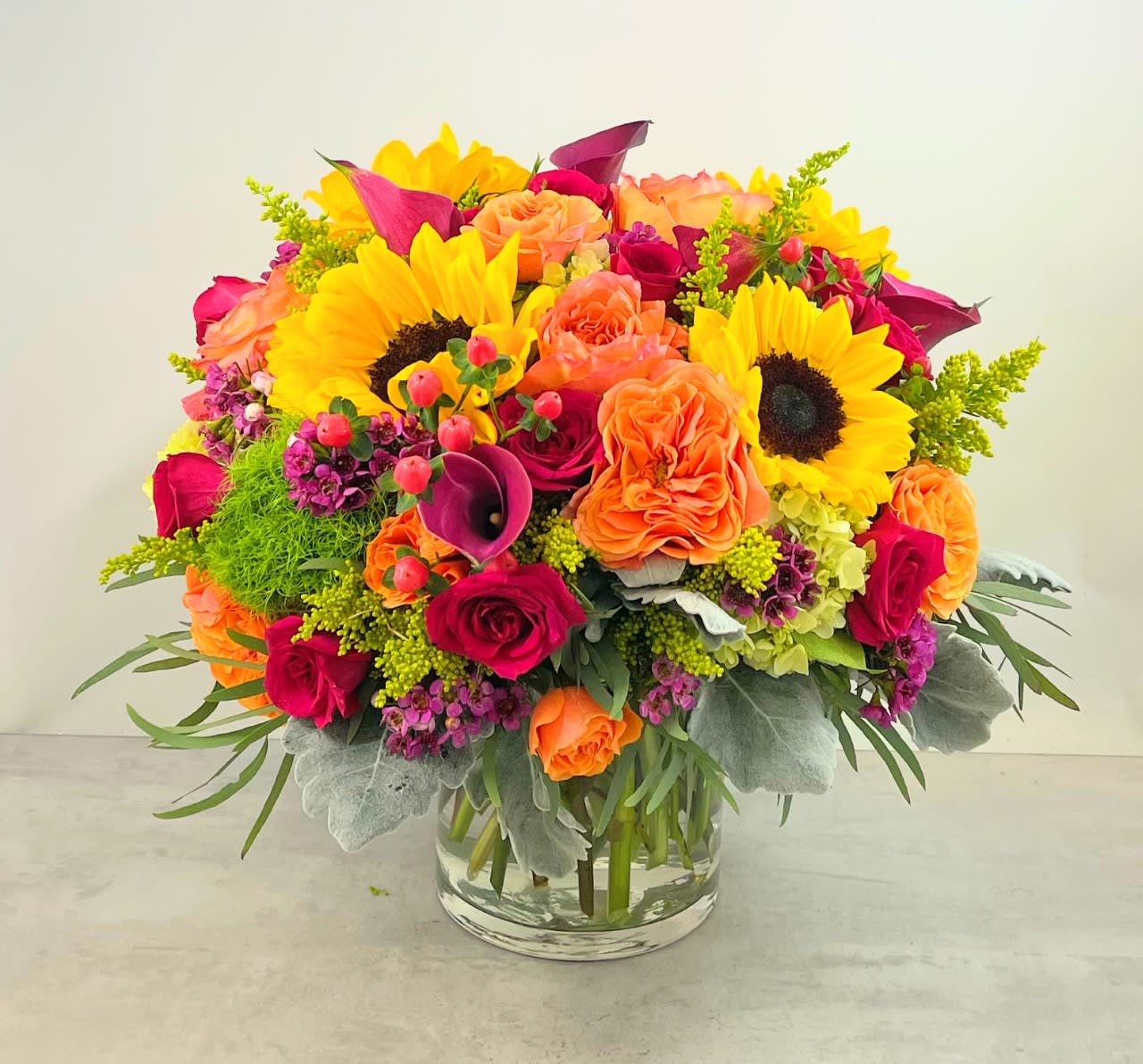 Citrus Mix Premium - Joy, happiness, and cheer are guaranteed with the Citrus Mix Premium!!! This wonderful overstuffed citrus inspired combination of mango callas, orange dianthus, Sweet Unique&quot; roses, sunflowers and hydrangea says it all.  All are sure to enjoy this one! 