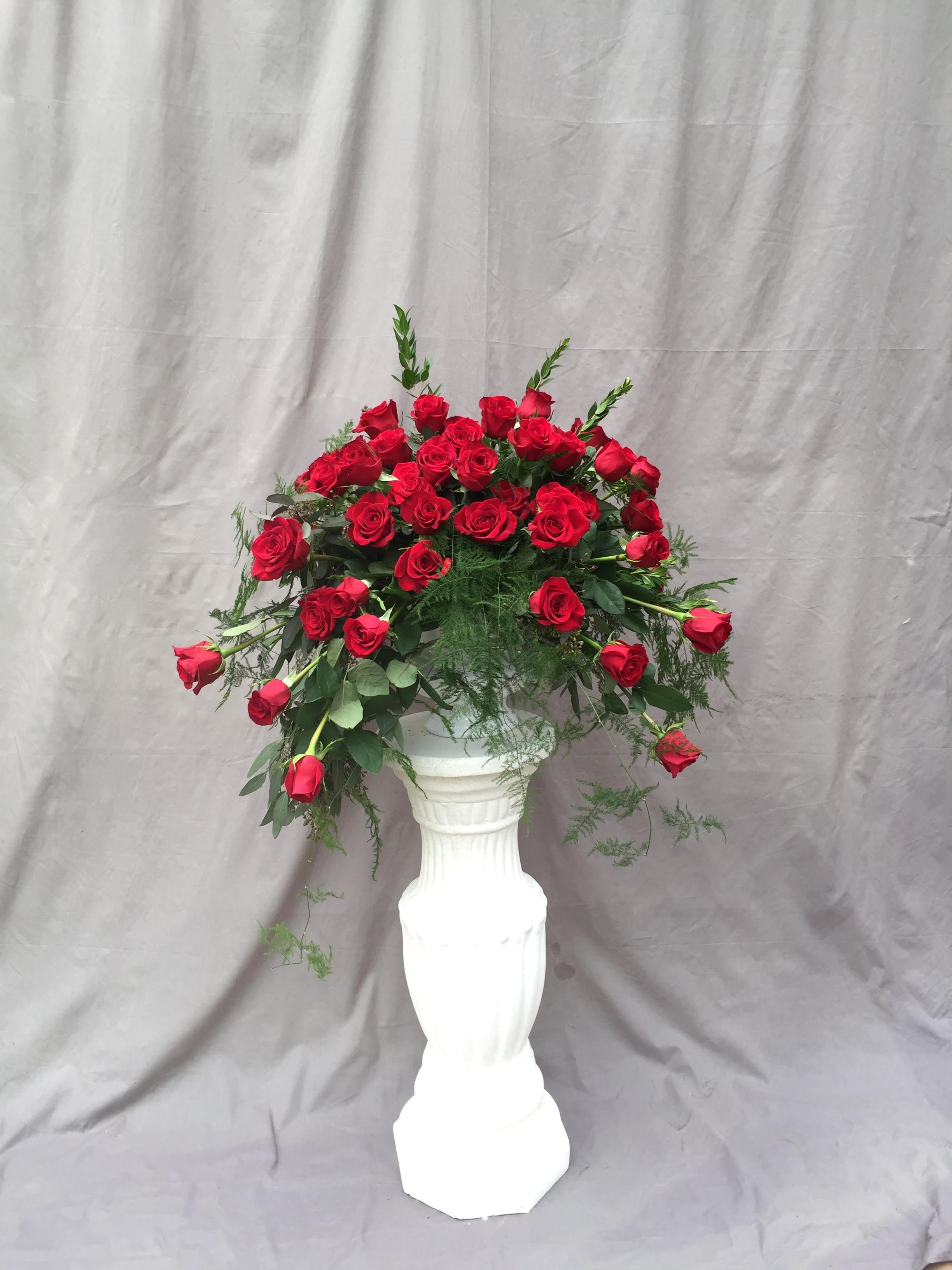 Red Rose Sympathy Urn Red Rose Sympathy Urn - Our beautiful red freedom roses with lush greenery make a lovely tribute to your loved one.